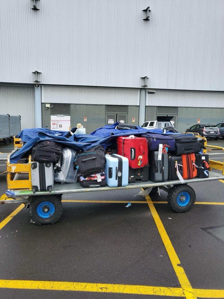 Items of luggage were stored outside by handlers 'at capacity' during flood disruption. Photo / Supplied