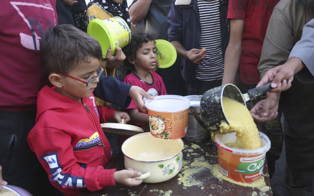 Palestinians line up for food during the ongoing Israeli bombardment of the Gaza Strip in Rafah. Photo / AP