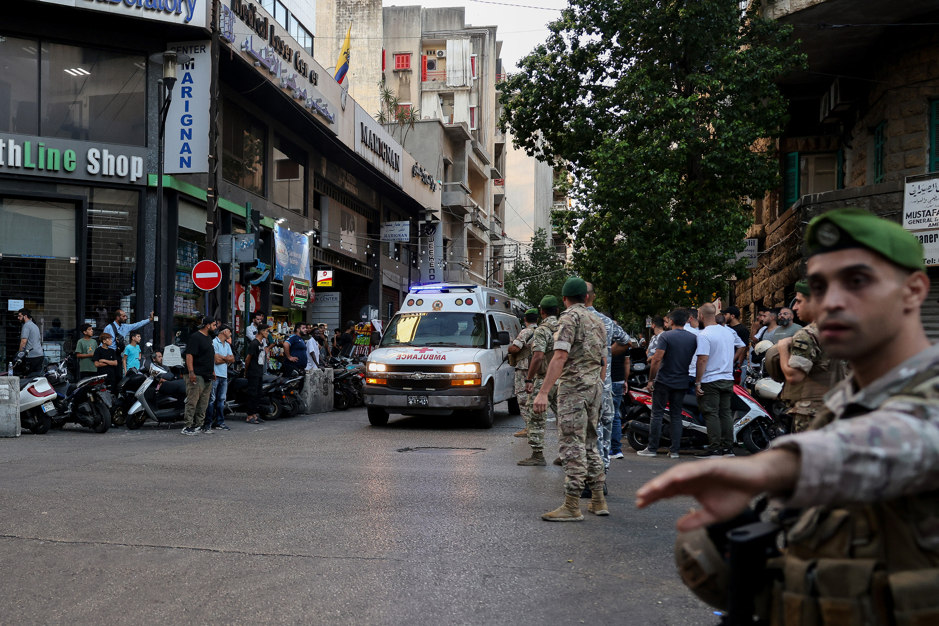Lebanese army soldiers stand guard as an ambulance rushes wounded people to a hospital in Beirut after explosions hit locations in several Hezbollah strongholds around Lebanon. Photo / Anwar Amro, AFP