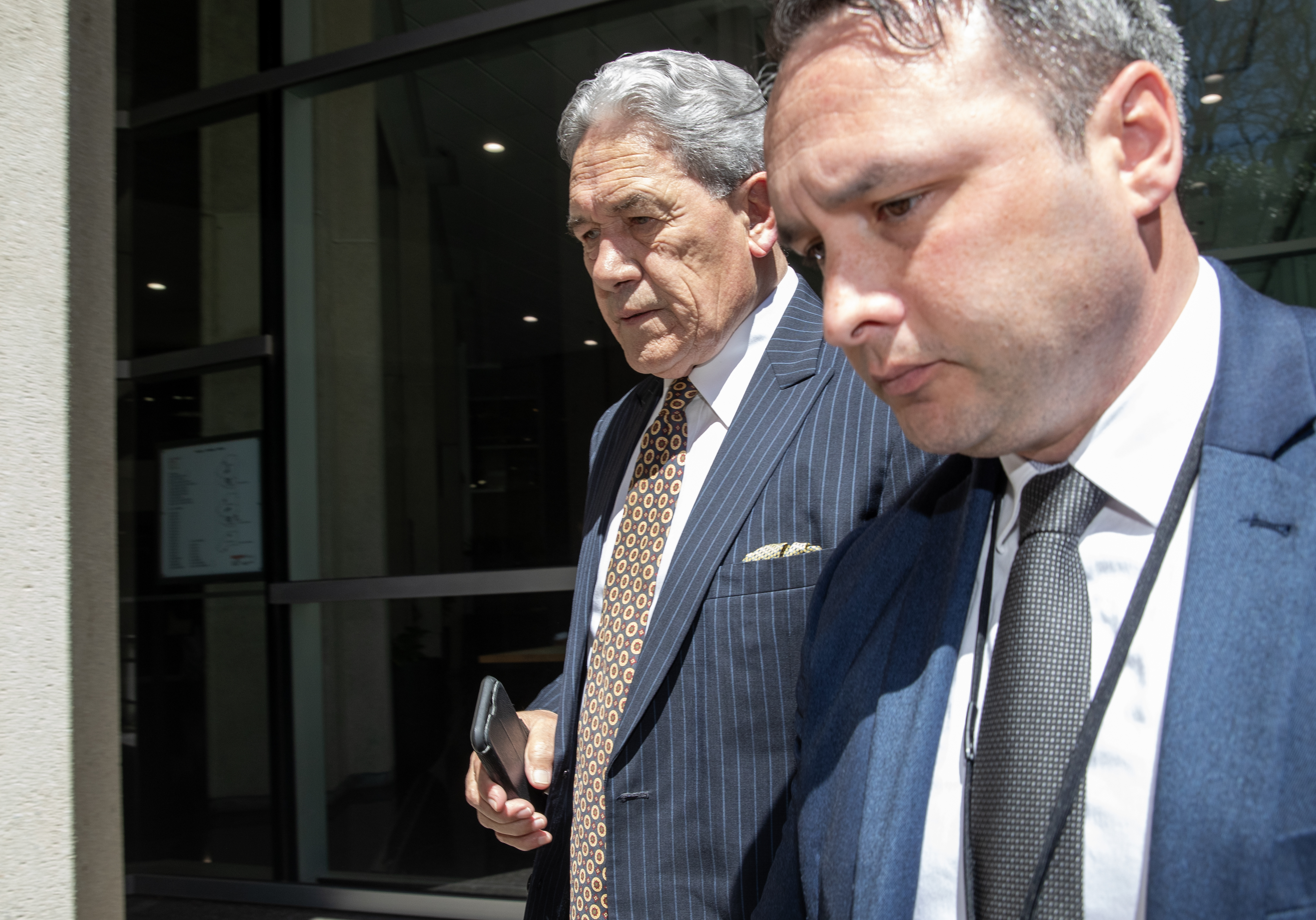 NZ First leader Winston Peters arrives at his party's base in Wellington alongside campaign manager Darroch Ball (right). Photo / Mark Mitchell