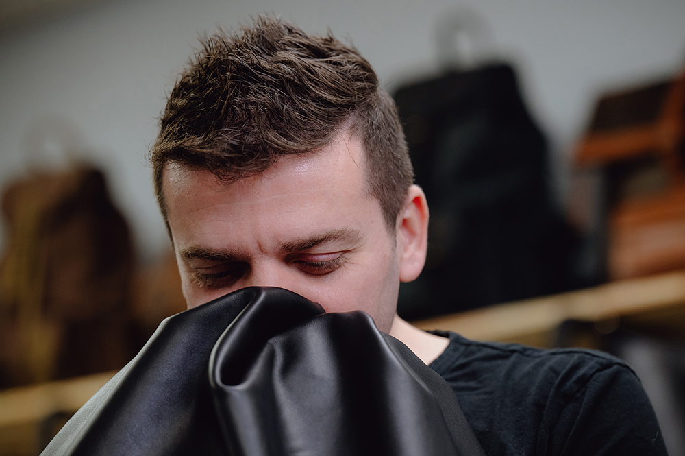Yilmaz smells leather at Pegai. Photo / Desiree Rios, The New York Times