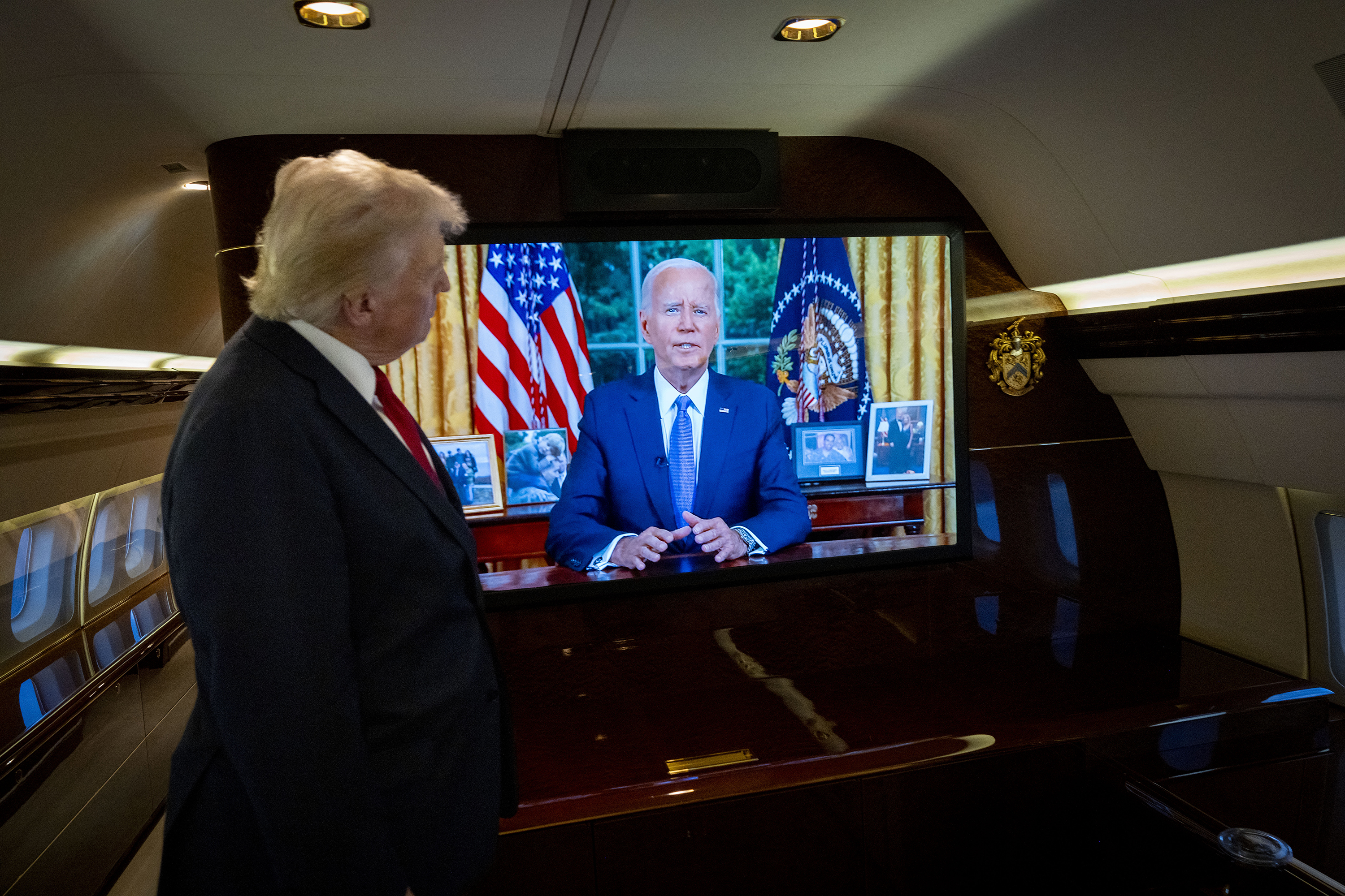 Donald Trump watches on board his plane as President Joe Biden addresses the US on July, 24, when he announced his departure from the election campaign. Photo / Doug Mills, the New York Times
