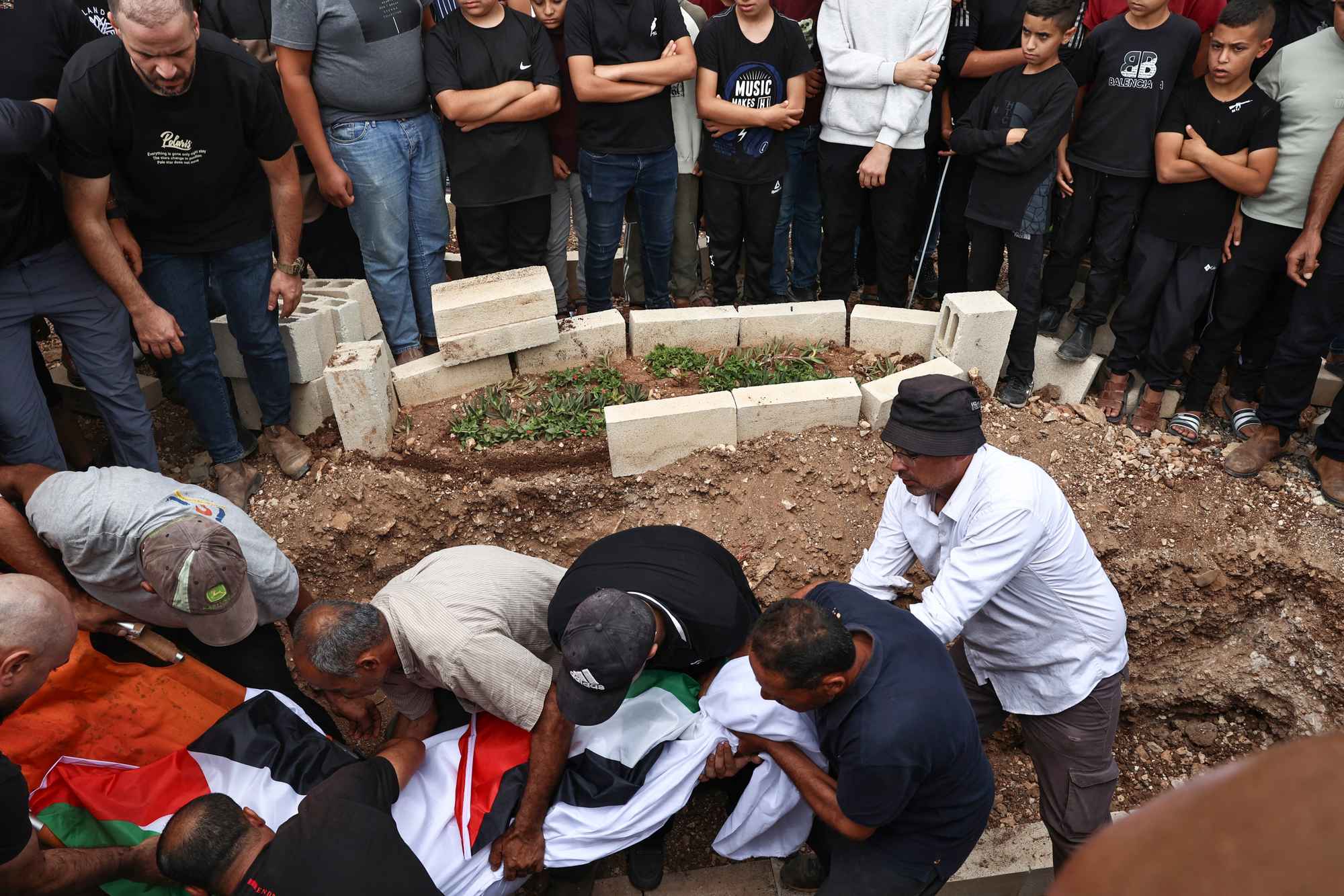 Mourners bury Hanan Abdel Rahman Abu Salama, 59, after she was killed by Israeli fire in the occupied-West Bank village of Faqoua near Jenin, on October 17. Photo / AFP