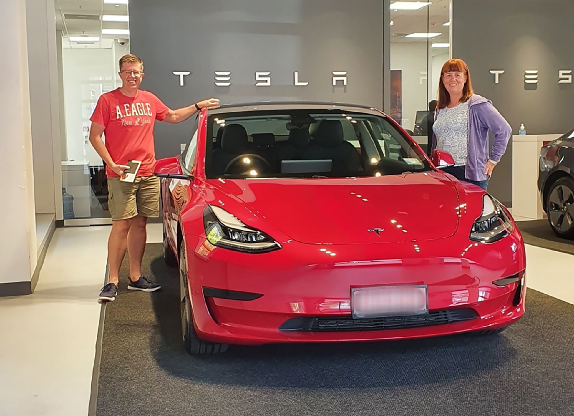 Craig and Susan Shearer collect their new Tesla electric car from the showroom in central Auckland in February 2021.
