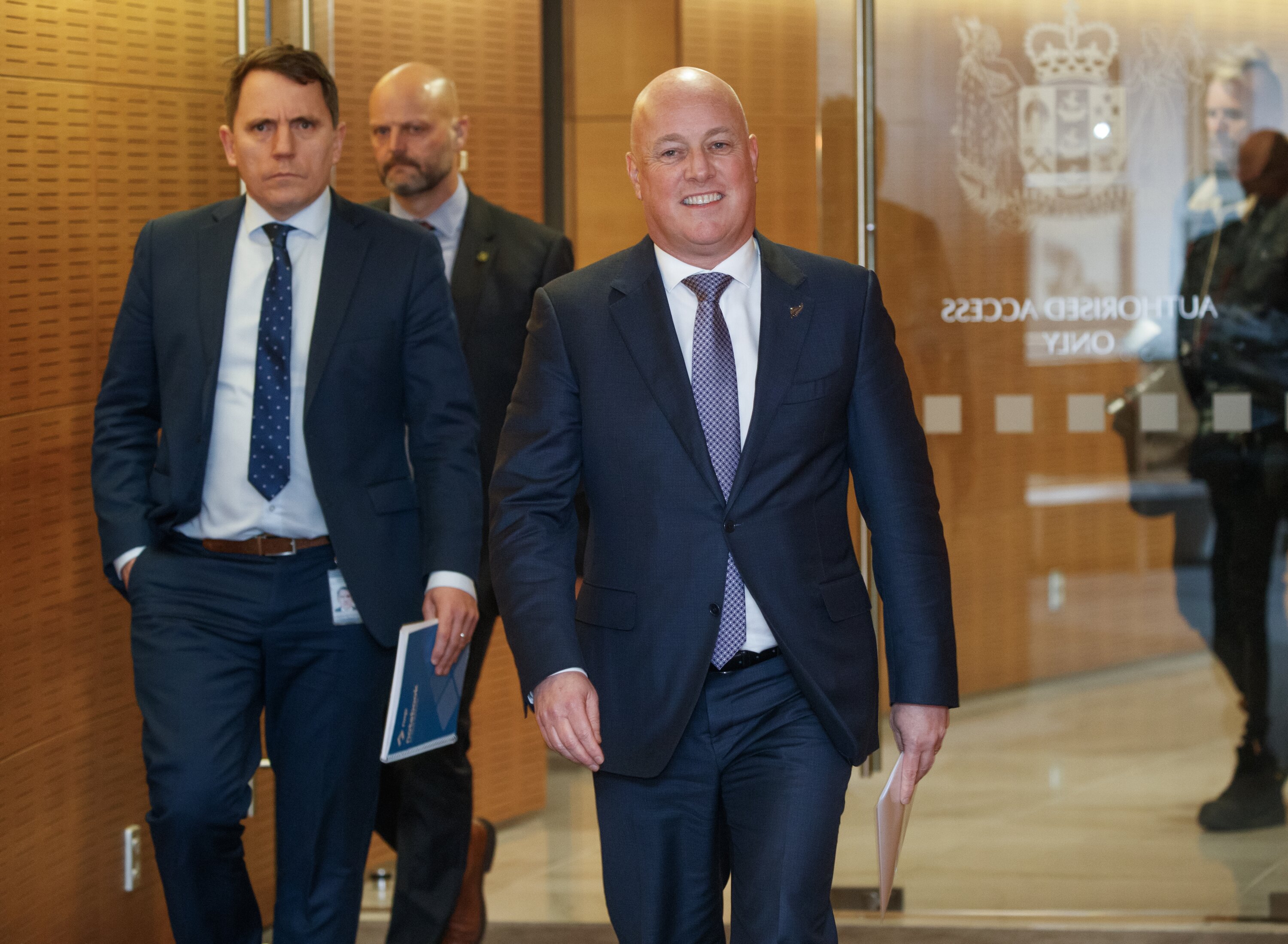 Prime Minister Christopher Luxon arrives for a post-Cabinet press conference with Hamish Rutherford (far left). Photo / Mark Mitchell