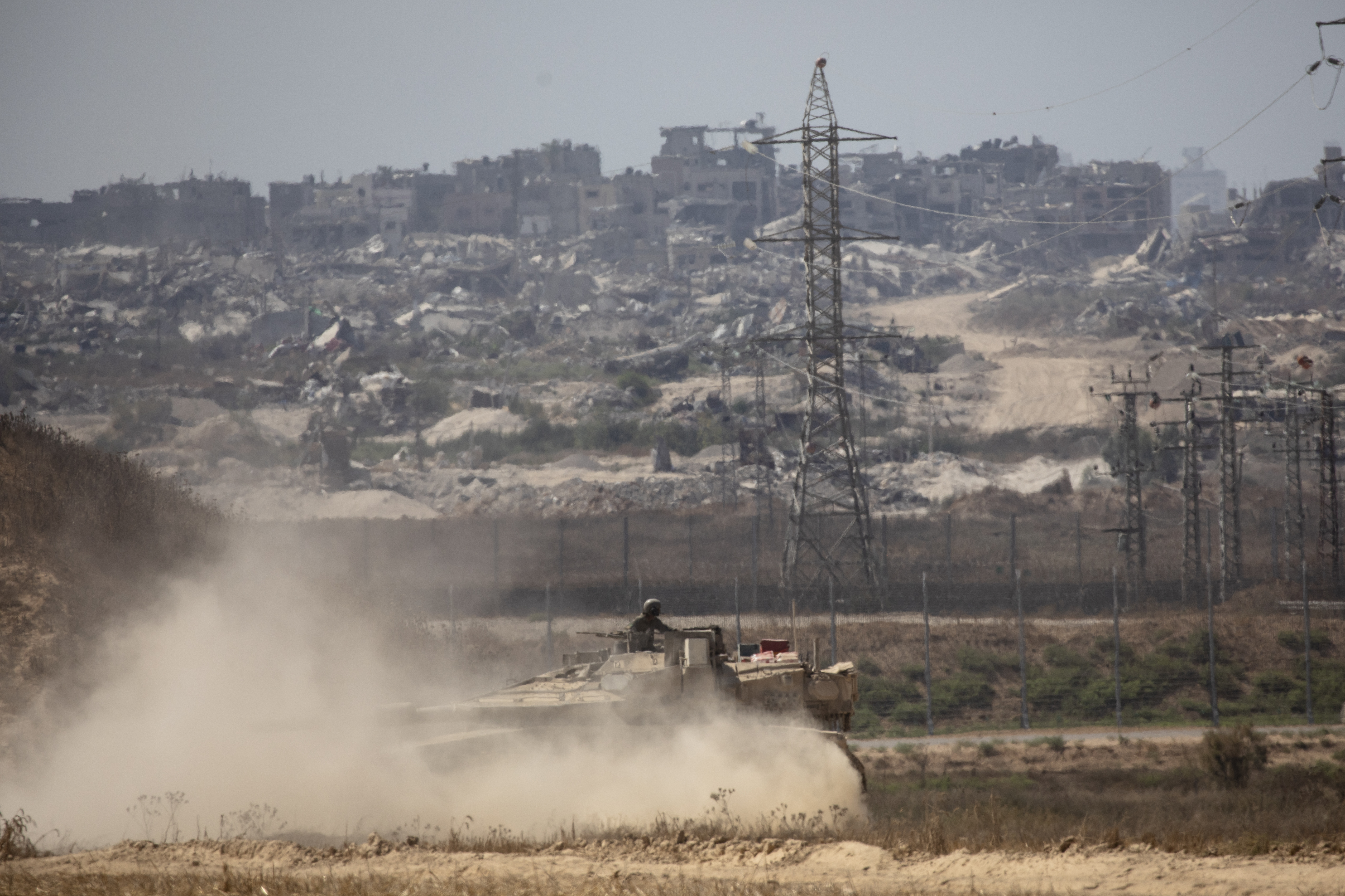 An Israeli soldier stands on a tank as it is driven near the border with the Gaza Strip as seen from a position on the Israeli side of the border on June 28, 2024 in southern Israel. Photo / Getty Images