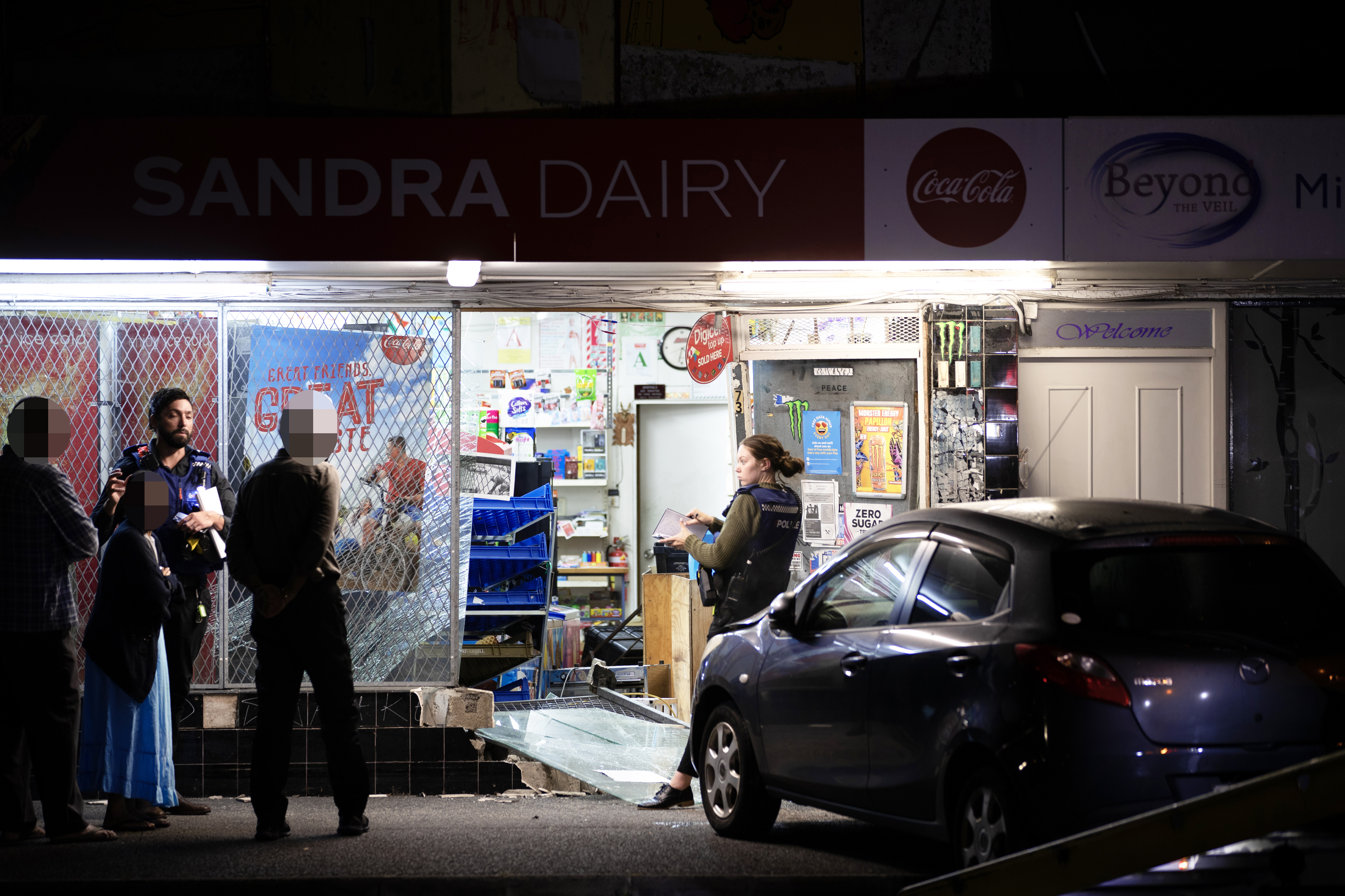 Police outside the Sandra Dairy, in Ellerslie, after a ram-raid last year. Photo / Hayden Woodward