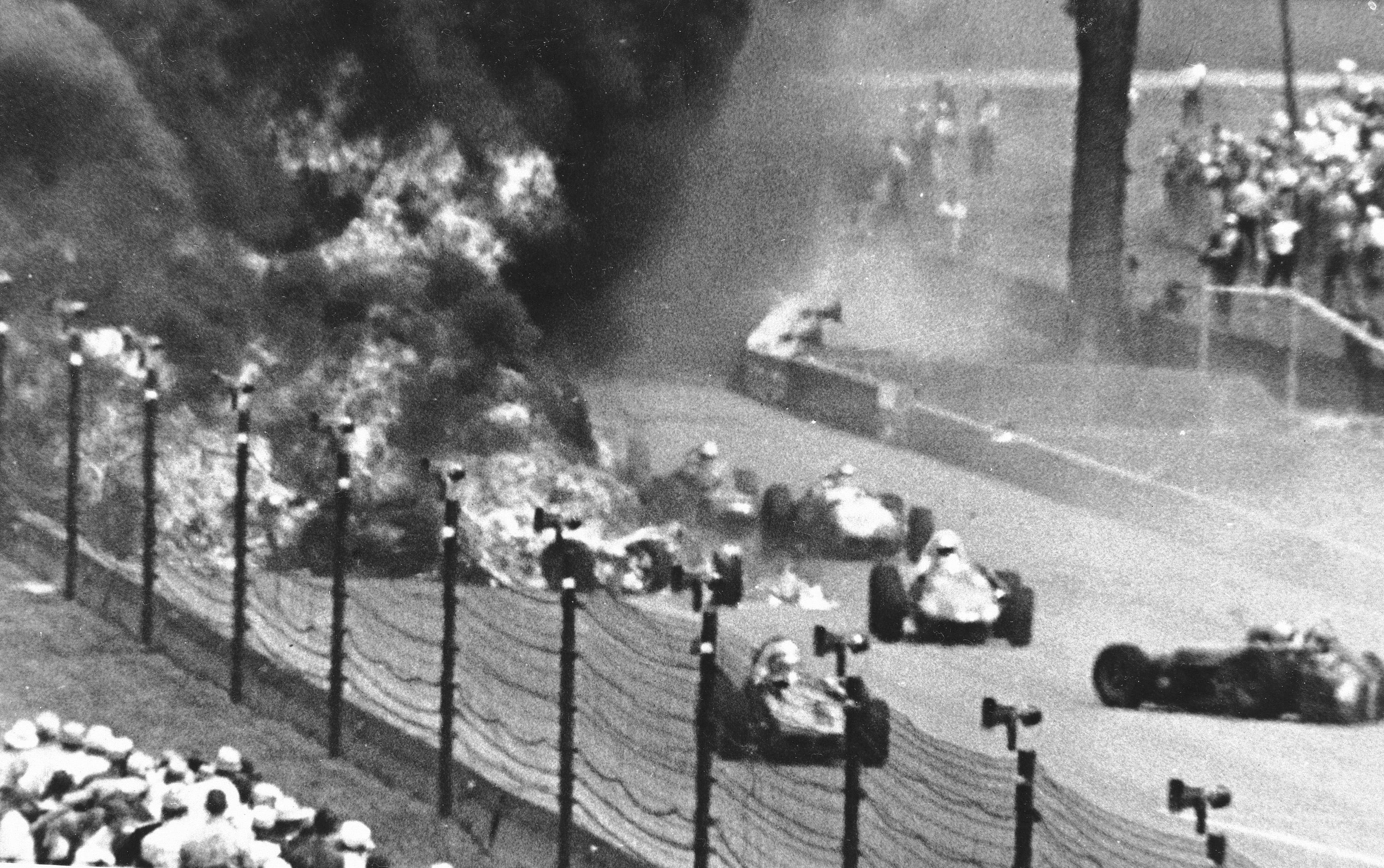 Drivers weave through blazing wreckage after a crash on the second lap of the Indianapolis 500 auto race at Indianapolis Motor Speedway in Indianapolis on May 30, 1964. Eddie Sachs and Dave MacDonald were killed in the wreckage. The fiery crash that took the lives of Sachs and MacDonald led to more firefighters being hired for races. Photo / AP