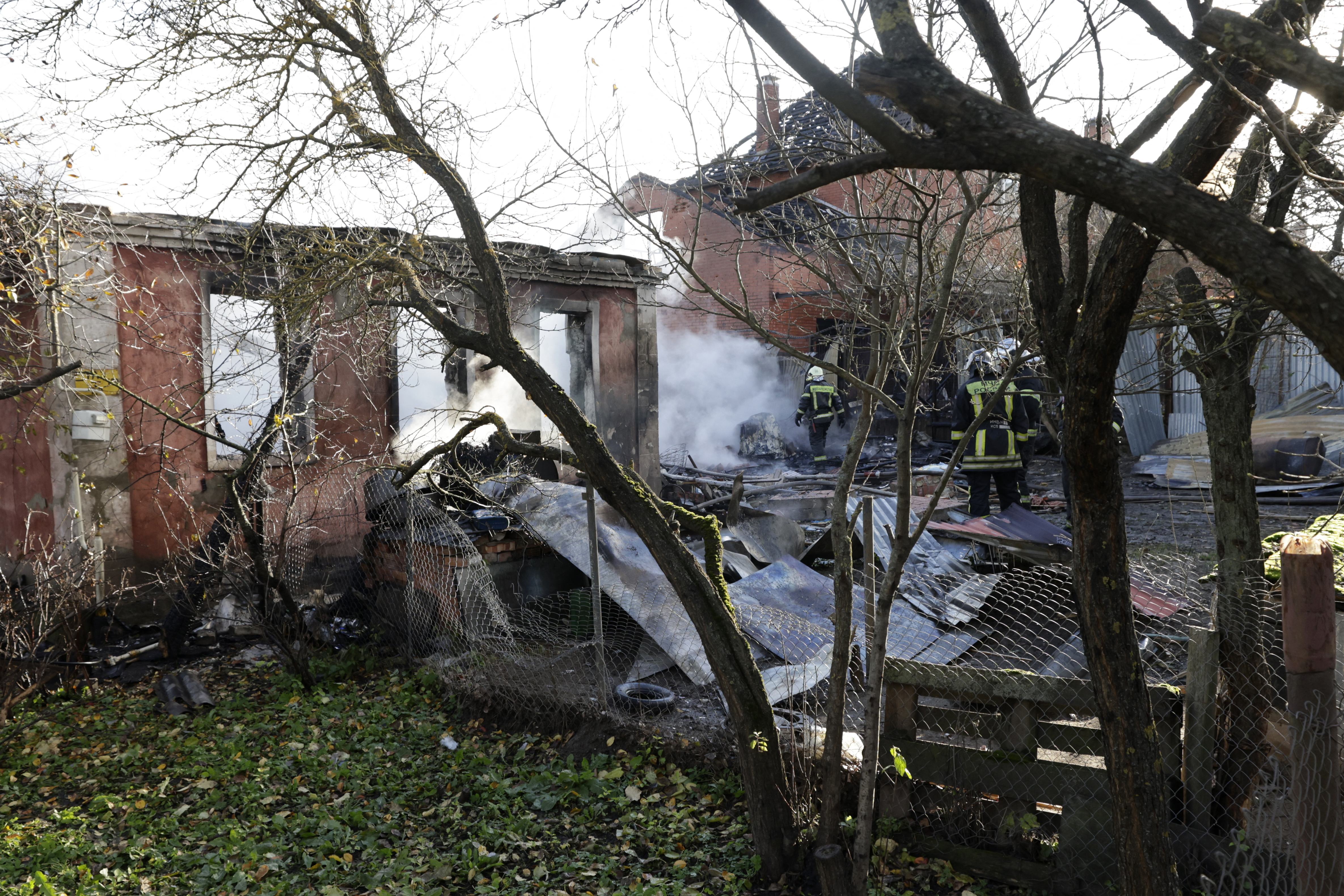 Rescuers work to extinguish a fire in a house after a drone attack in the village of Stanovoye, Moscow region, on Sunday. Photo / AFP