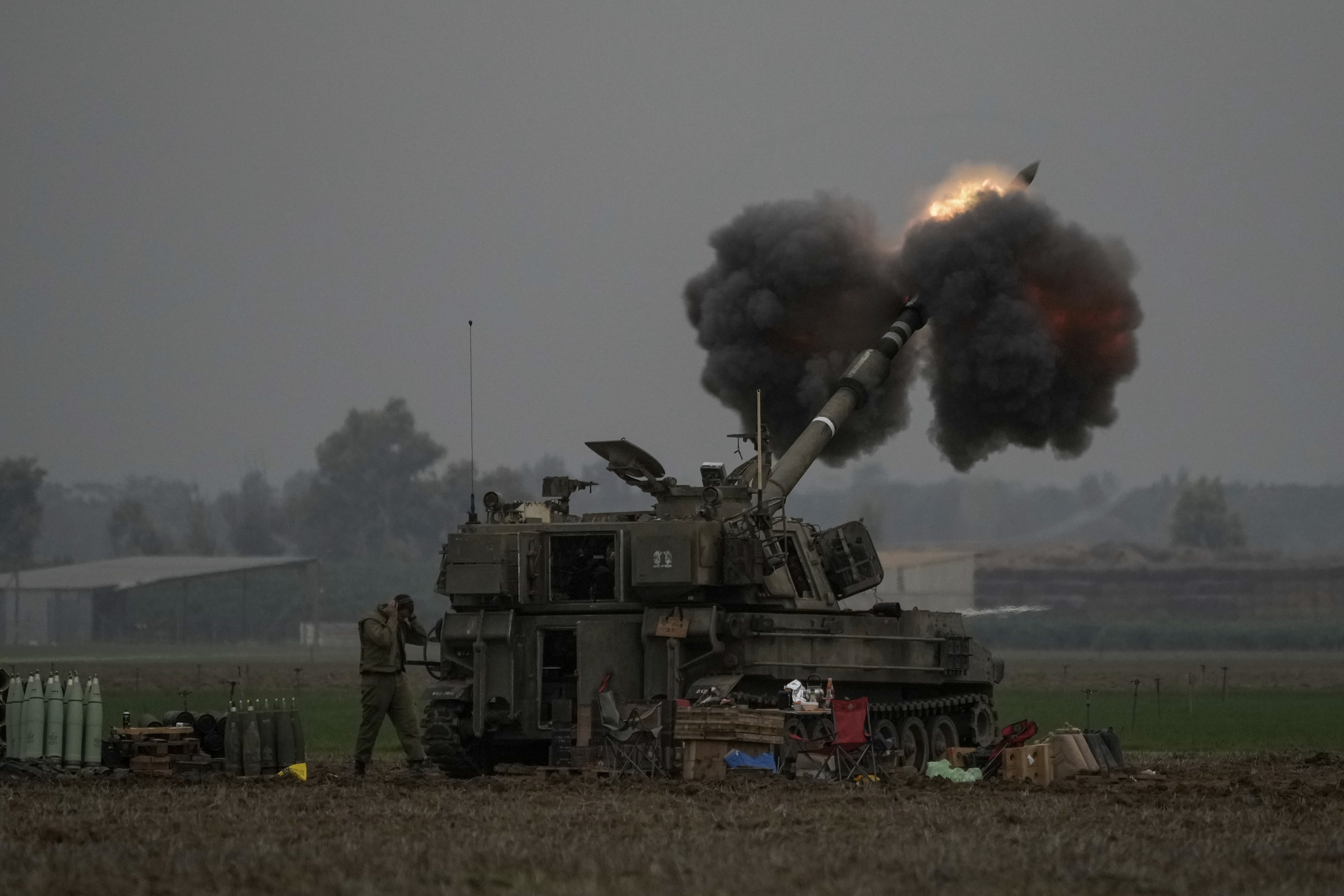 An Israeli mobile artillery unit fires a shell from southern Israel towards the Gaza Strip. Photo / AP