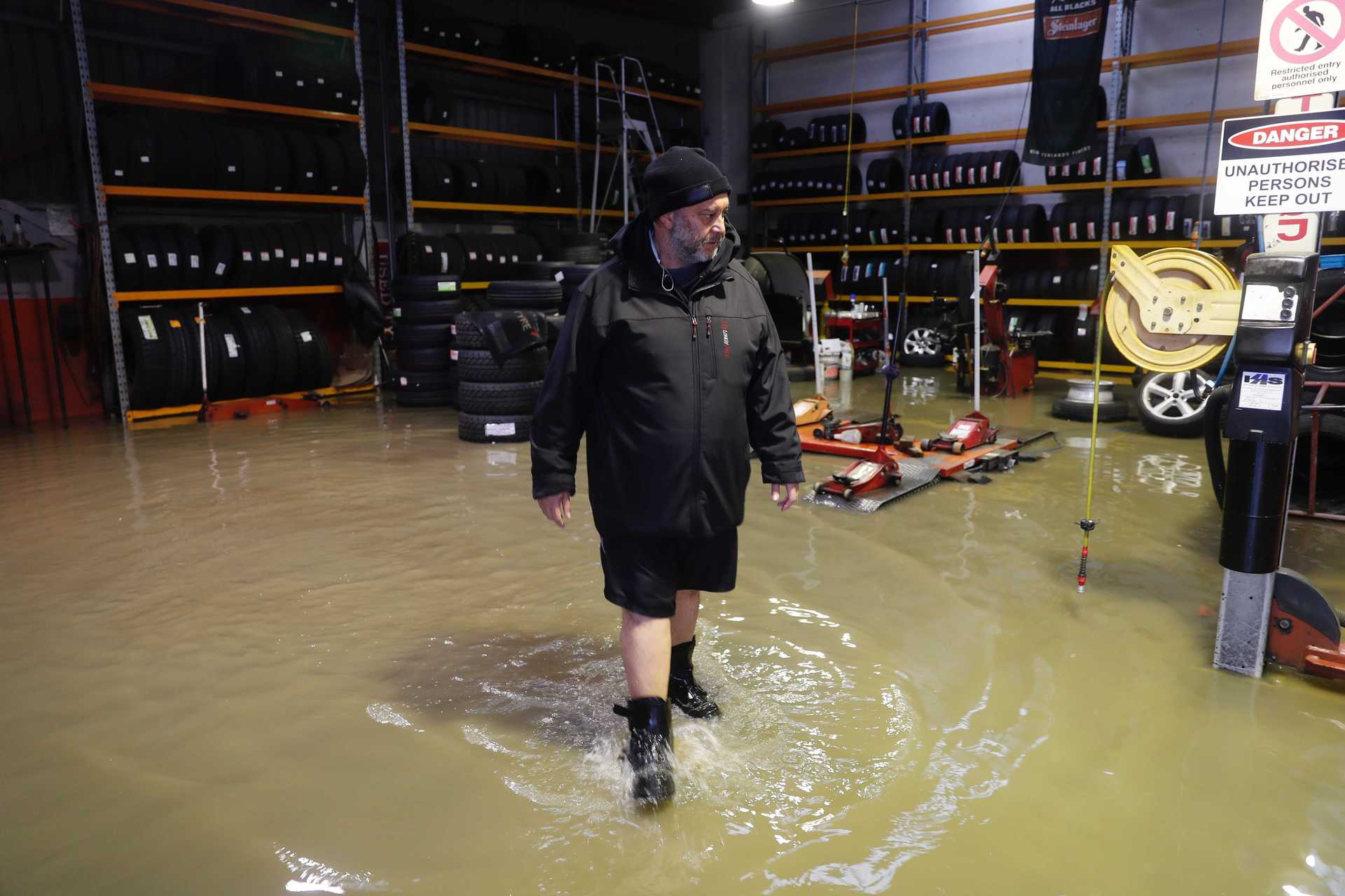 Johnny Mills, owner of Bridgestone Tyres in Kumeu, says the water is rising again. Photo / Dean Purcell