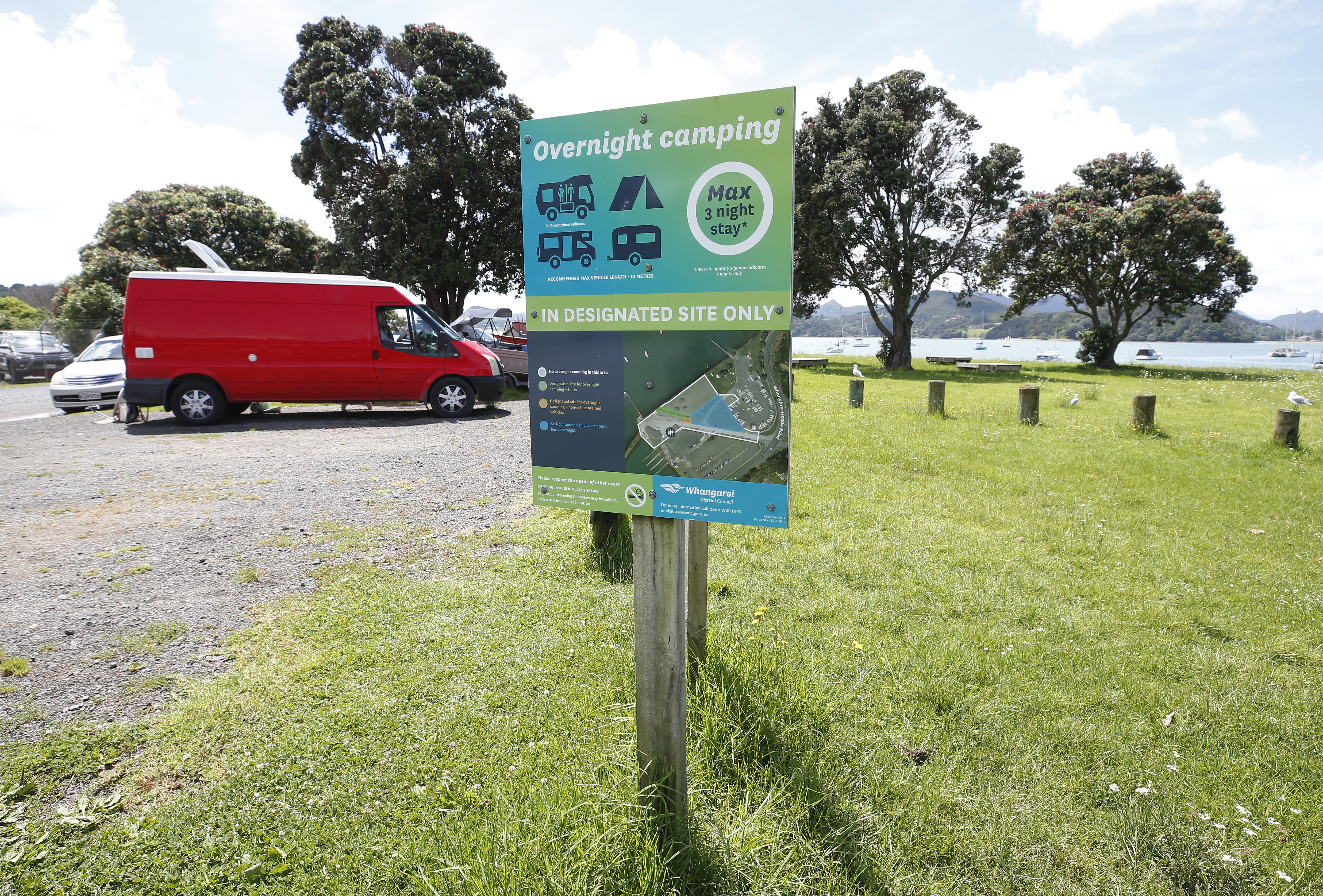 A large sign details the normal freedom rules, including a three-night stay limit, for the tent site and other areas at Parua Bay. Photo / NZME