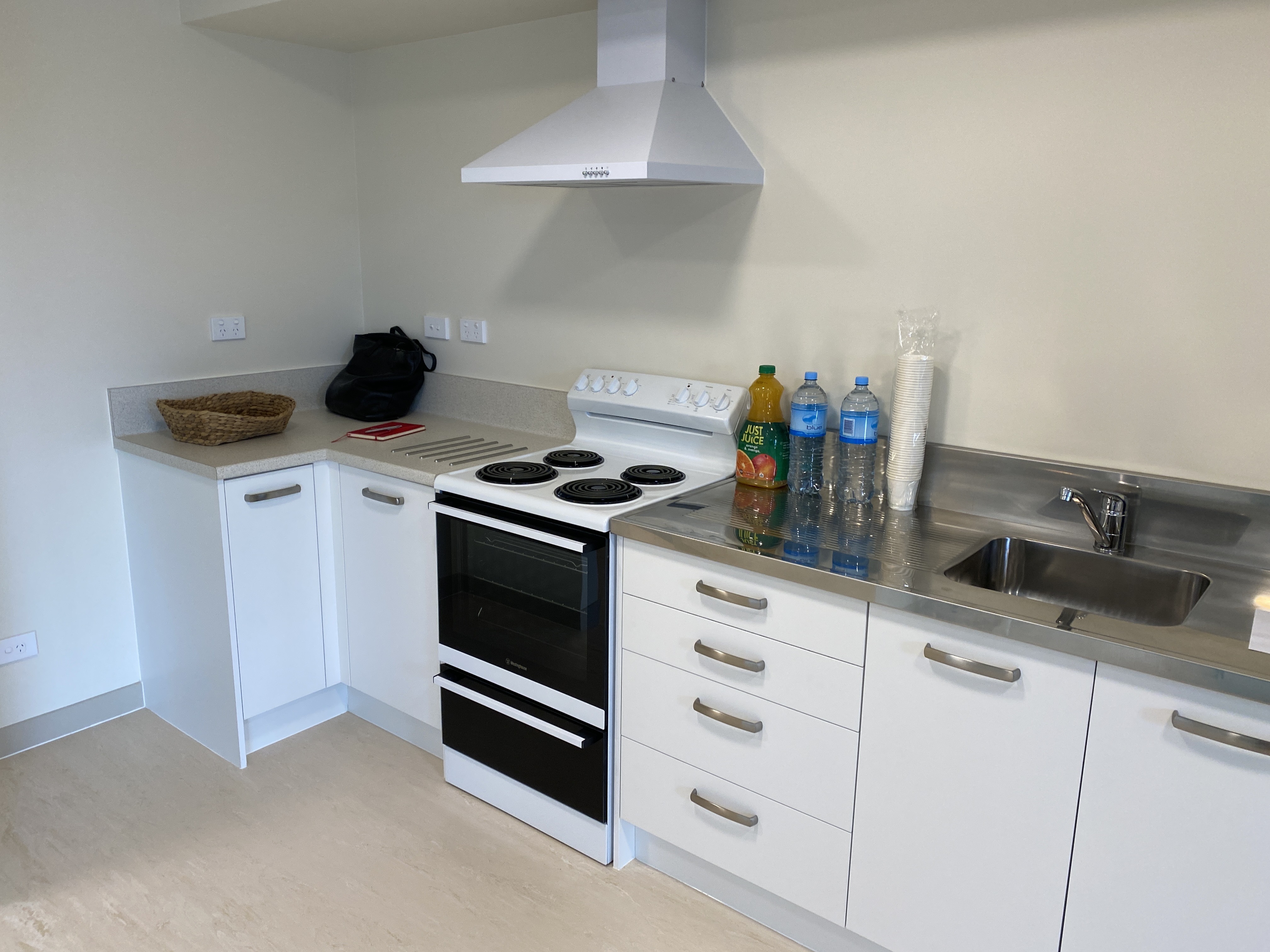 The apartment kitchens have stainless steel benchtops. 
