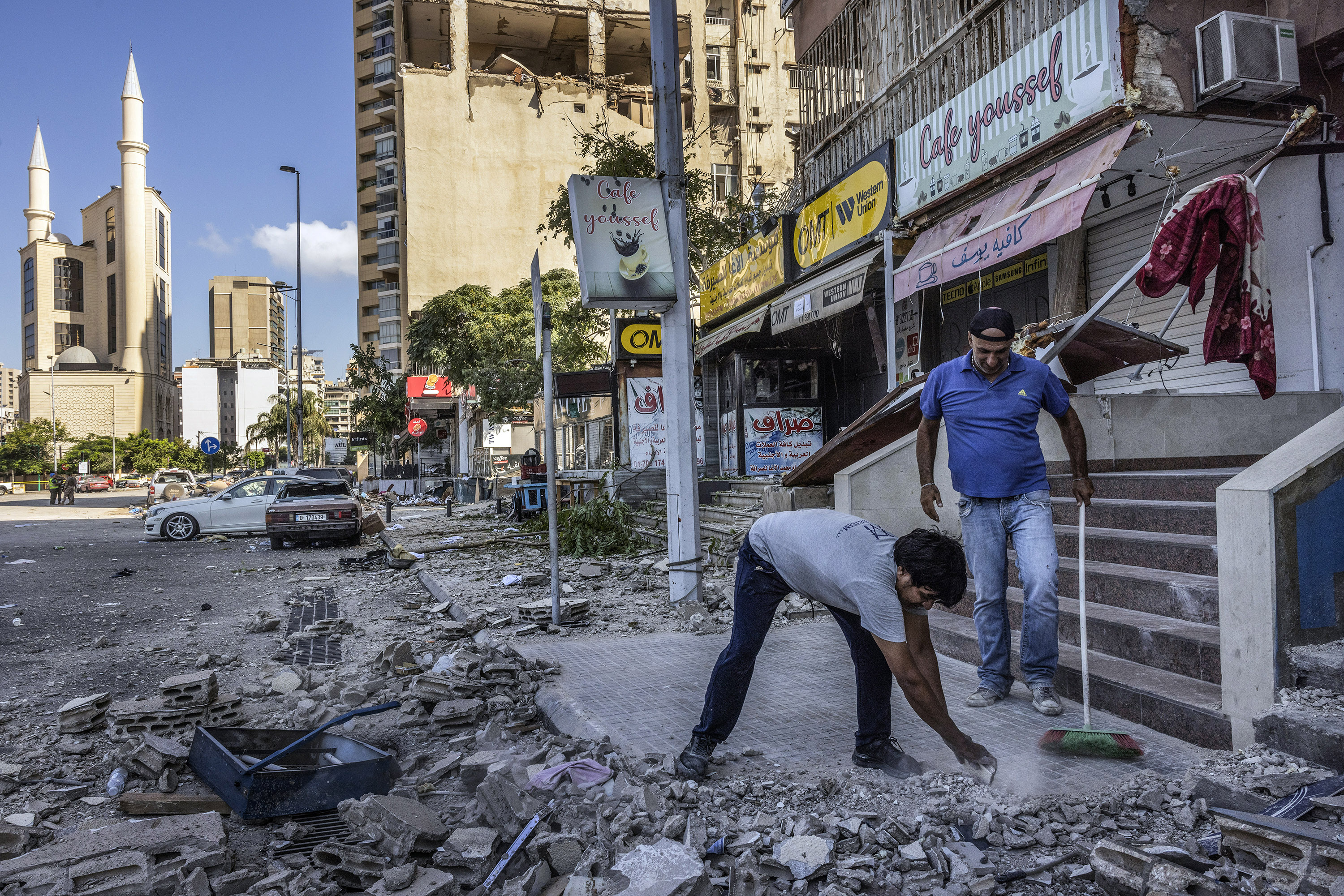 Residents in central Beirut, Lebanon, cleaning up after an overnight bombing by Israeli forces. It was believed to have been the first Israeli strike in central Beirut since at least 2006. Photo / David Guttenfelder, The New York Times