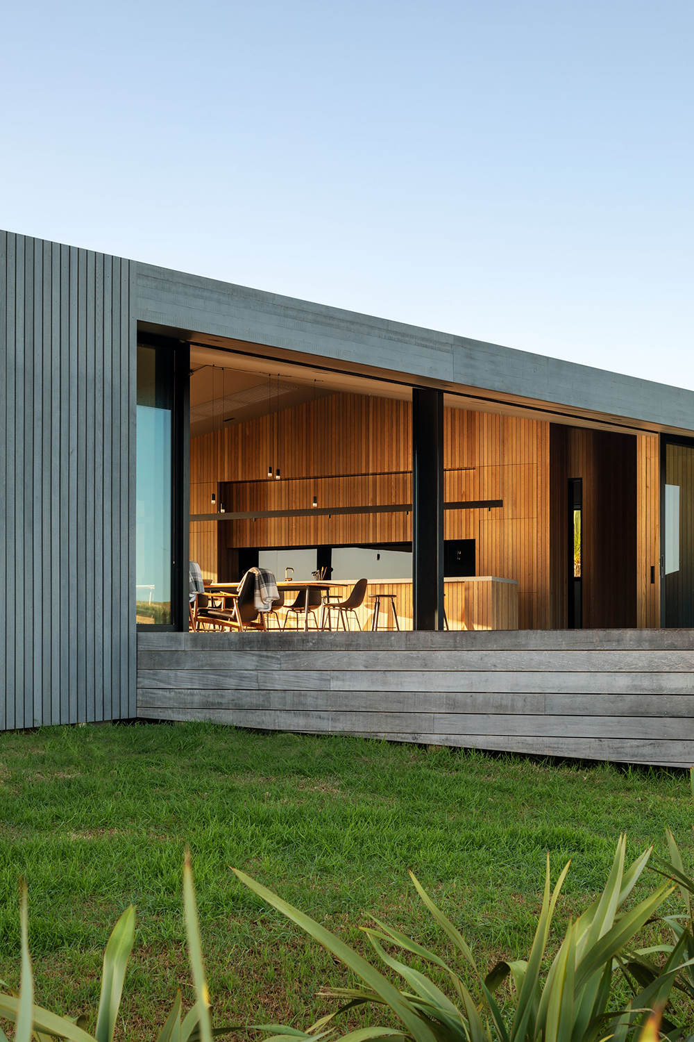 The striking cedar cladding was chosen for its rustic appeal and ability to blend with the surrounding bush. Photo / Simon Wilson