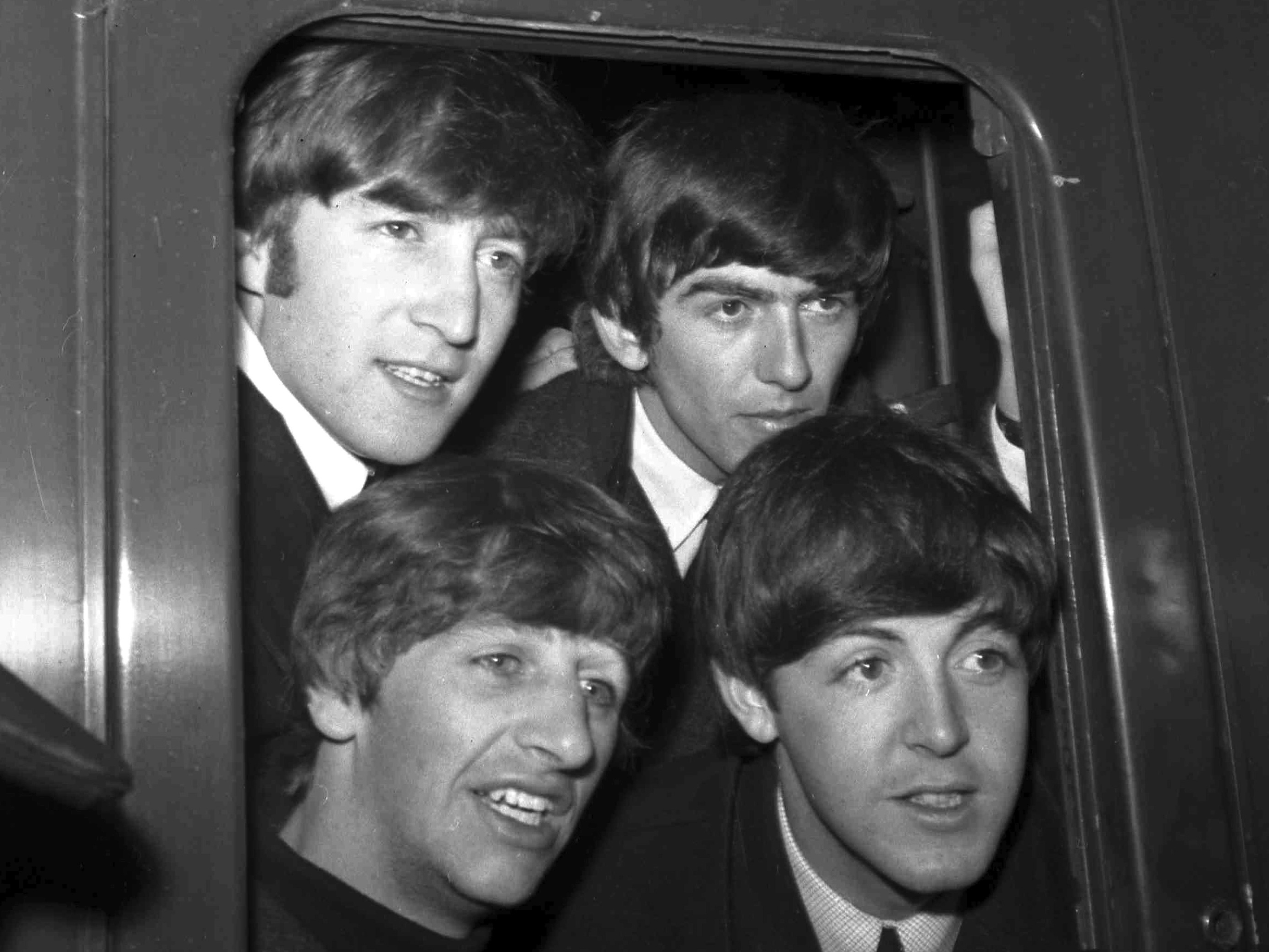 The Beatles, clockwise from top left, John Lennon, George Harrison, Paul McCartney and Ringo Starr, at Paddington Station in London, March 2, 1964. Photo / AP