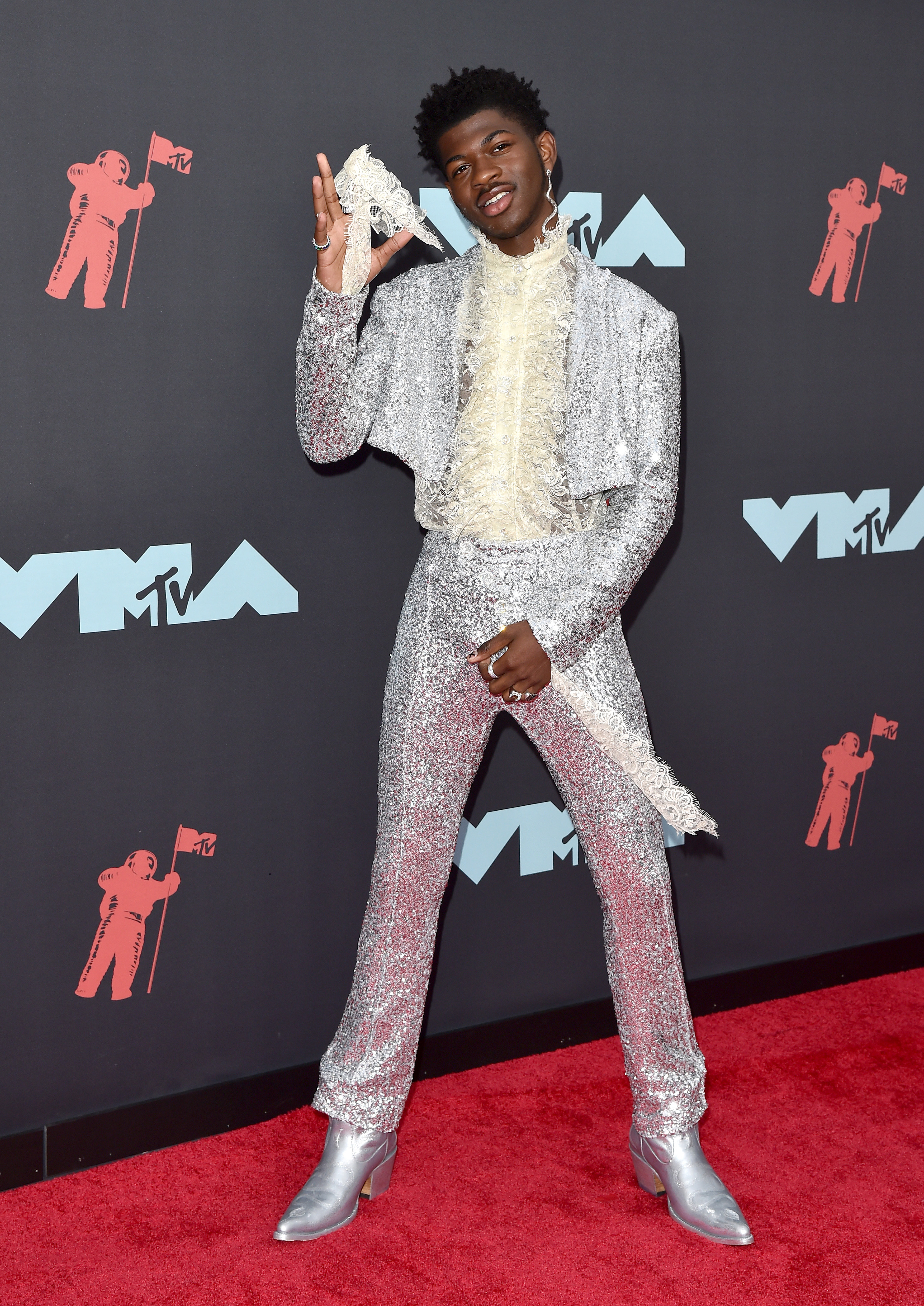 Lil Nas X wore a metallic silver suit and ruffled lace shirt to the 2019 MTV Video Music Awards. Photo / Getty Images