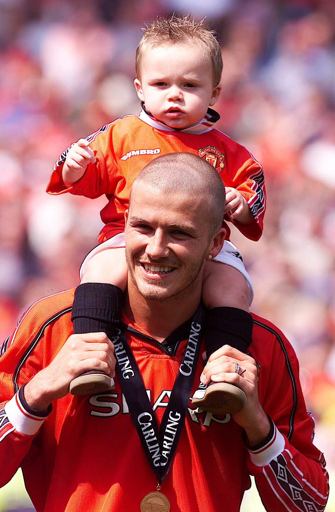 Manchester United's David Beckham carries his son Brooklyn on his shoulders, as his side are crowned FA Carling Premiership Champions after their match against Tottenham Hotspur. Photo / Getty Images