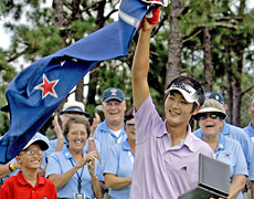 Danny Lee waves the New Zealand flag in celebration on the 14th green at Pinehurst today. Photo / AP