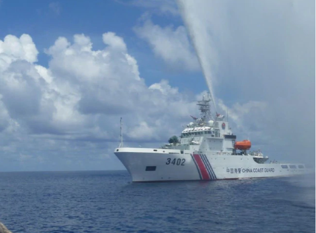 Chinese Coast Guard members approach Filipino fishermen as they confront each other off Scarborough Shoal in the South China Sea. Photo / AP