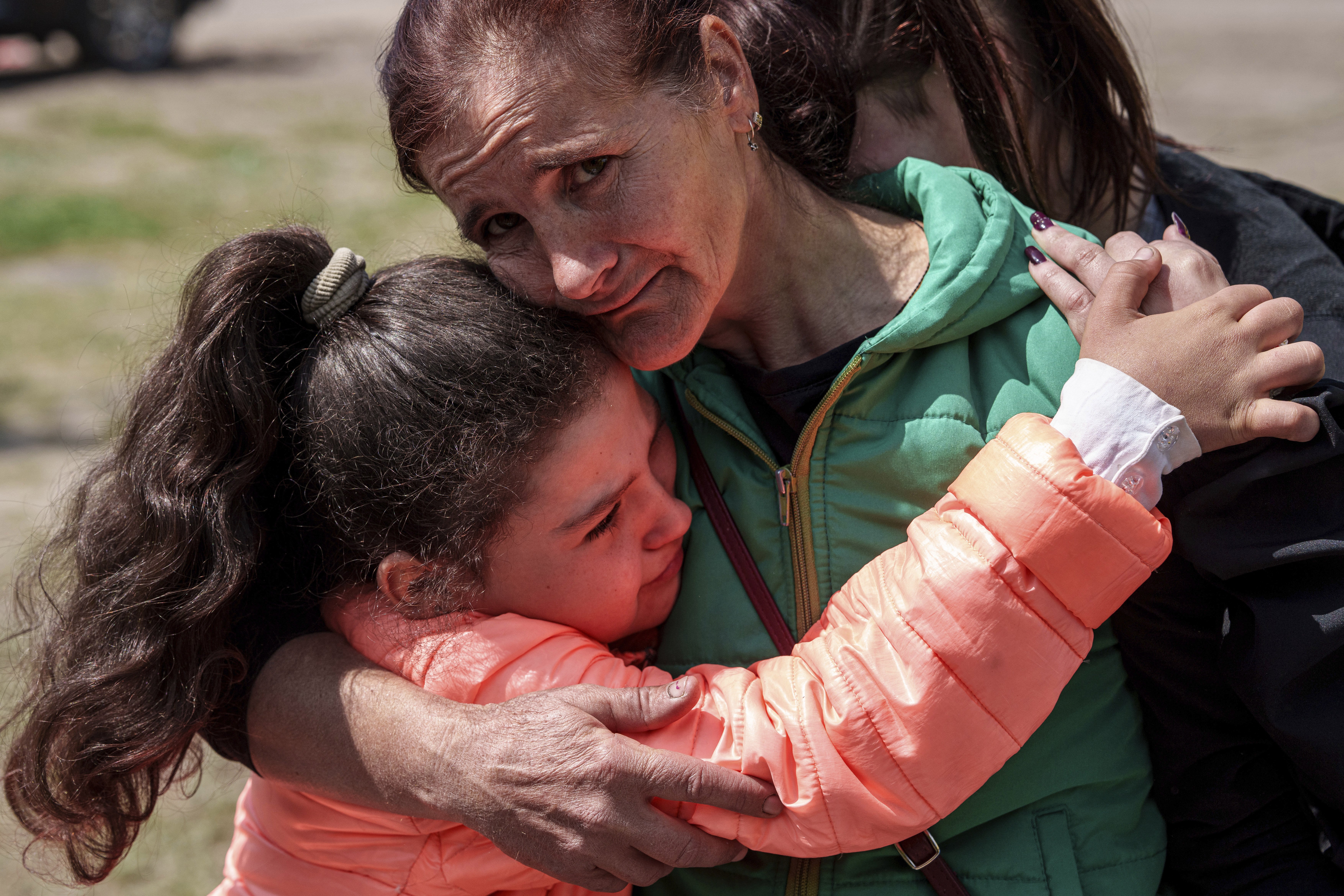 Khrystyna Pyimak, 11, hugs her mother Oksana Velychko, 42, after evacuation from Vovchansk, Ukraine, Sunday. Her husband was killed in their house after a Russian airstrike on the city. Photo / AP