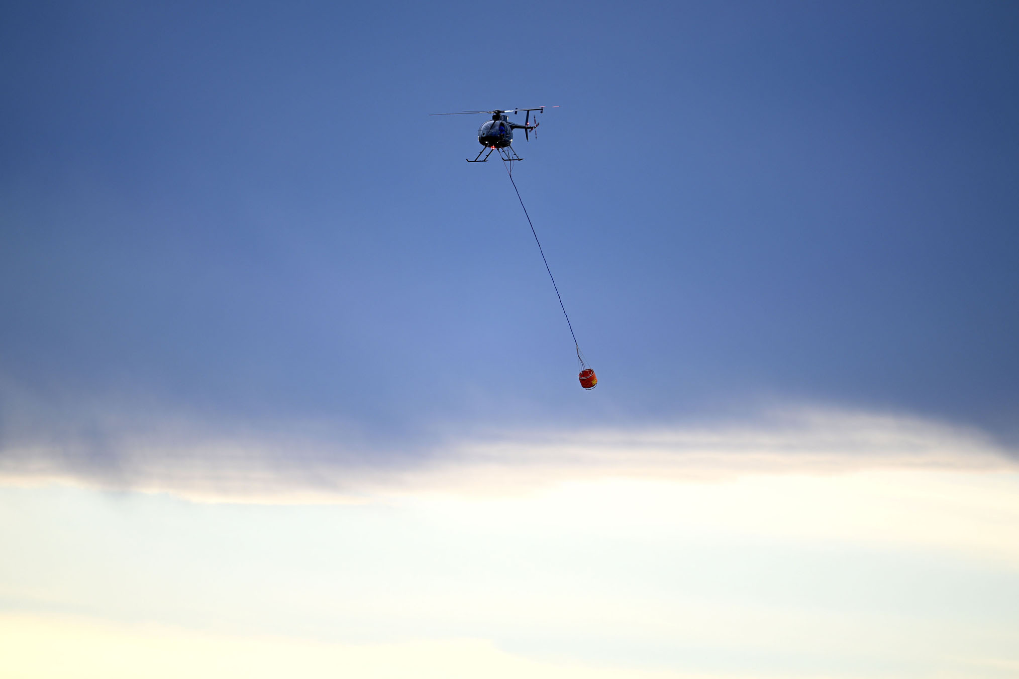A helicopter such as the one pictured had to be used to control a blaze dangerously close to the two Mōtatau fires. Photo / Joe Allison