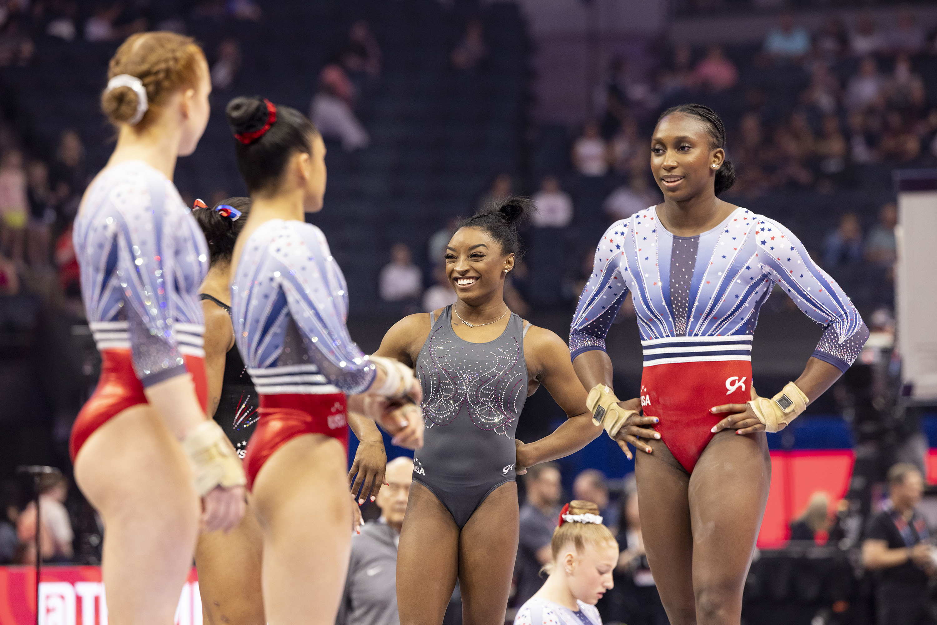 Biles, laughing with teammates during warm-ups at the US gymnastics trials last month, has become a mentor to younger athletes. Photo / Chang W. Lee, The New York Times