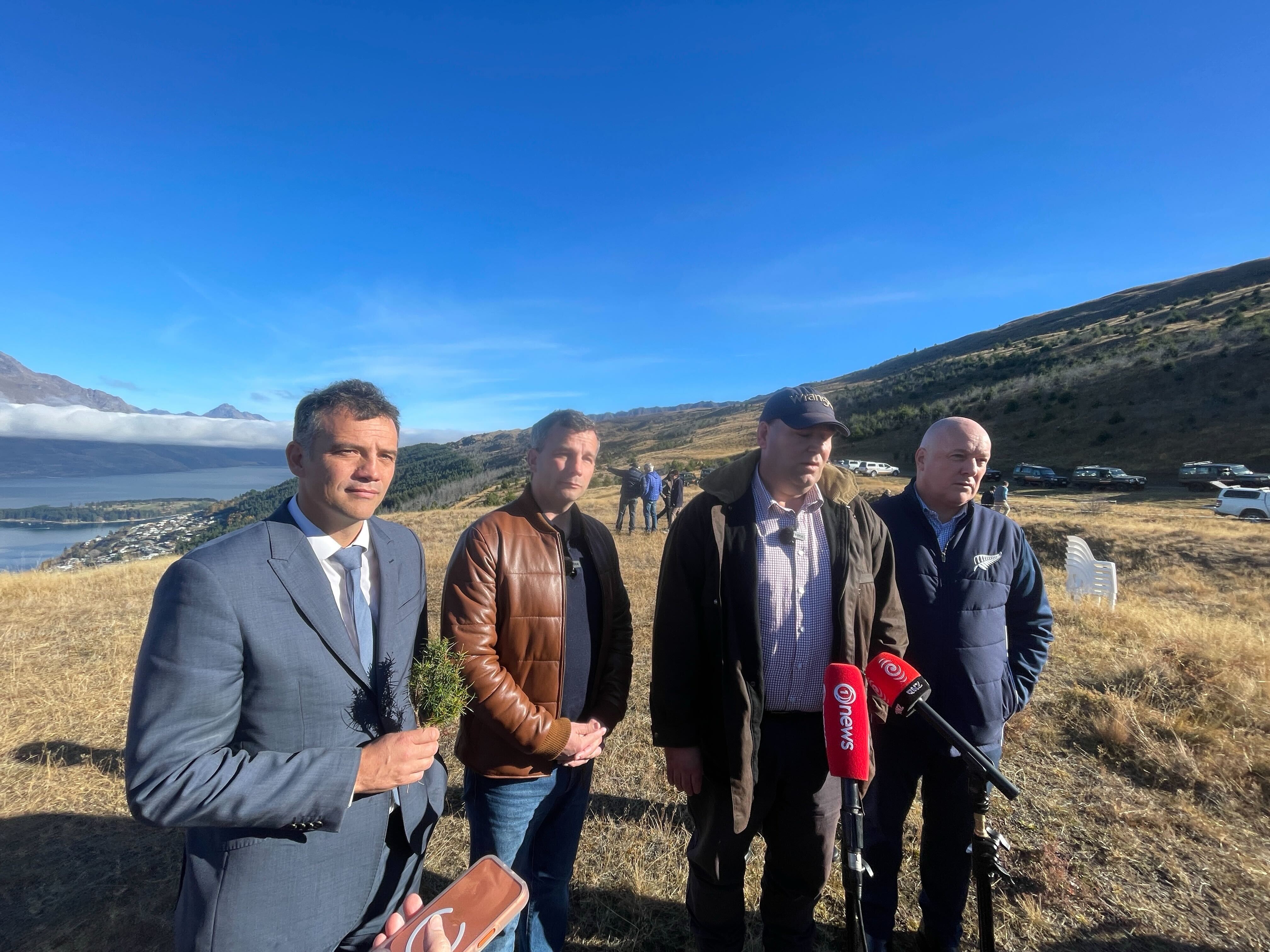 Southland MP Joseph Mooney, Act leader and Deputy PM David Seymour, Biosecurity Minister Andrew Hoggard, and Prime Minister Christopher Luxon above Lake Wakatipu, announcing extra funding for getting rid of wilding pines. Photo / Derek Cheng