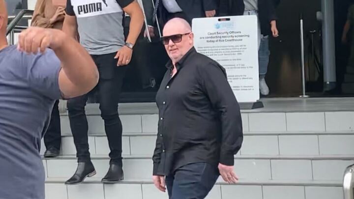 John Ferris leaves the Hamilton District Court with his supporters after being convicted of dangerous driving after a high speed crash in Wellington in February. Photo / Belinda Feek