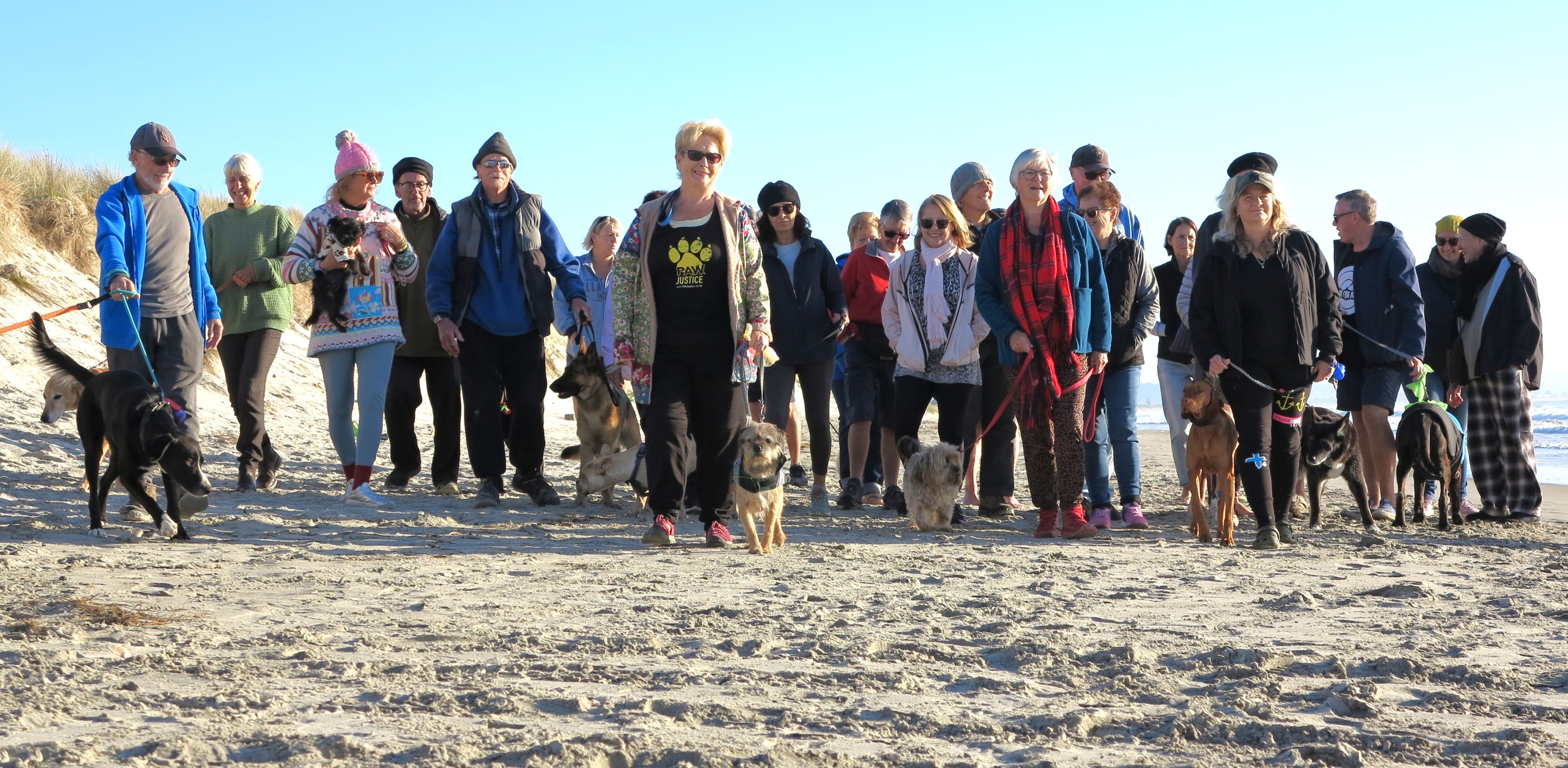 Mag Crichton (front centre) with some of the people who regularly exercise their dogs at a part of Uretiti Beach they call Dog Heaven. About 40 of them met on the beach this month to discuss their concerns over Whangārei District Council's proposed changes to access. 