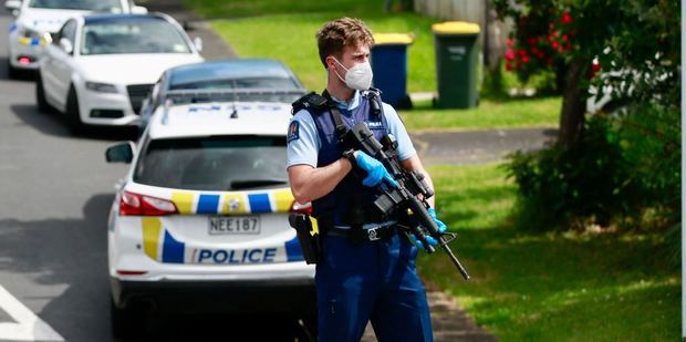 Armed police officers at the scene in Glen Eden. Photo / Alex Burton