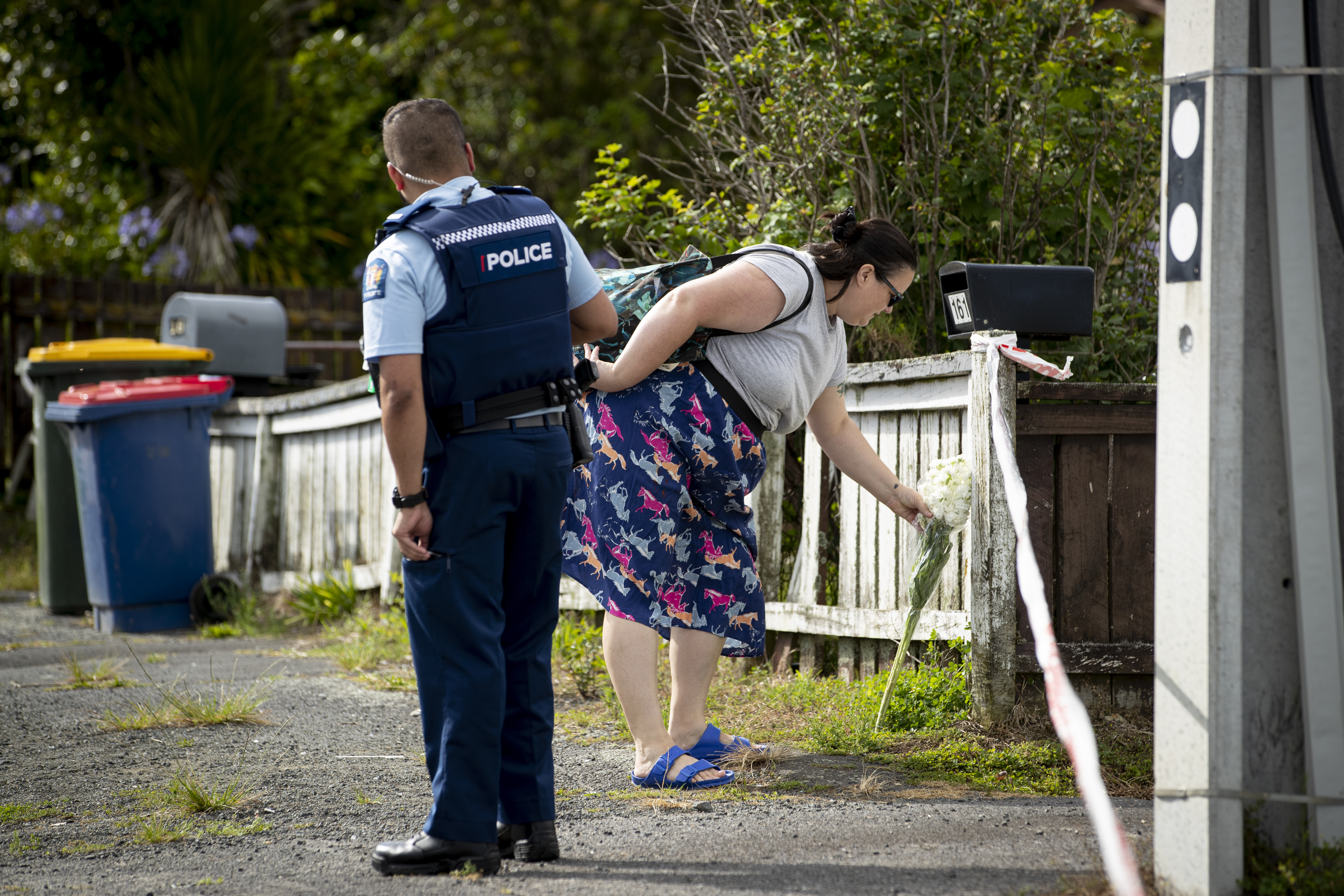 A woman lays flowers near where Yaqubi died. Photo / Dean Purcell