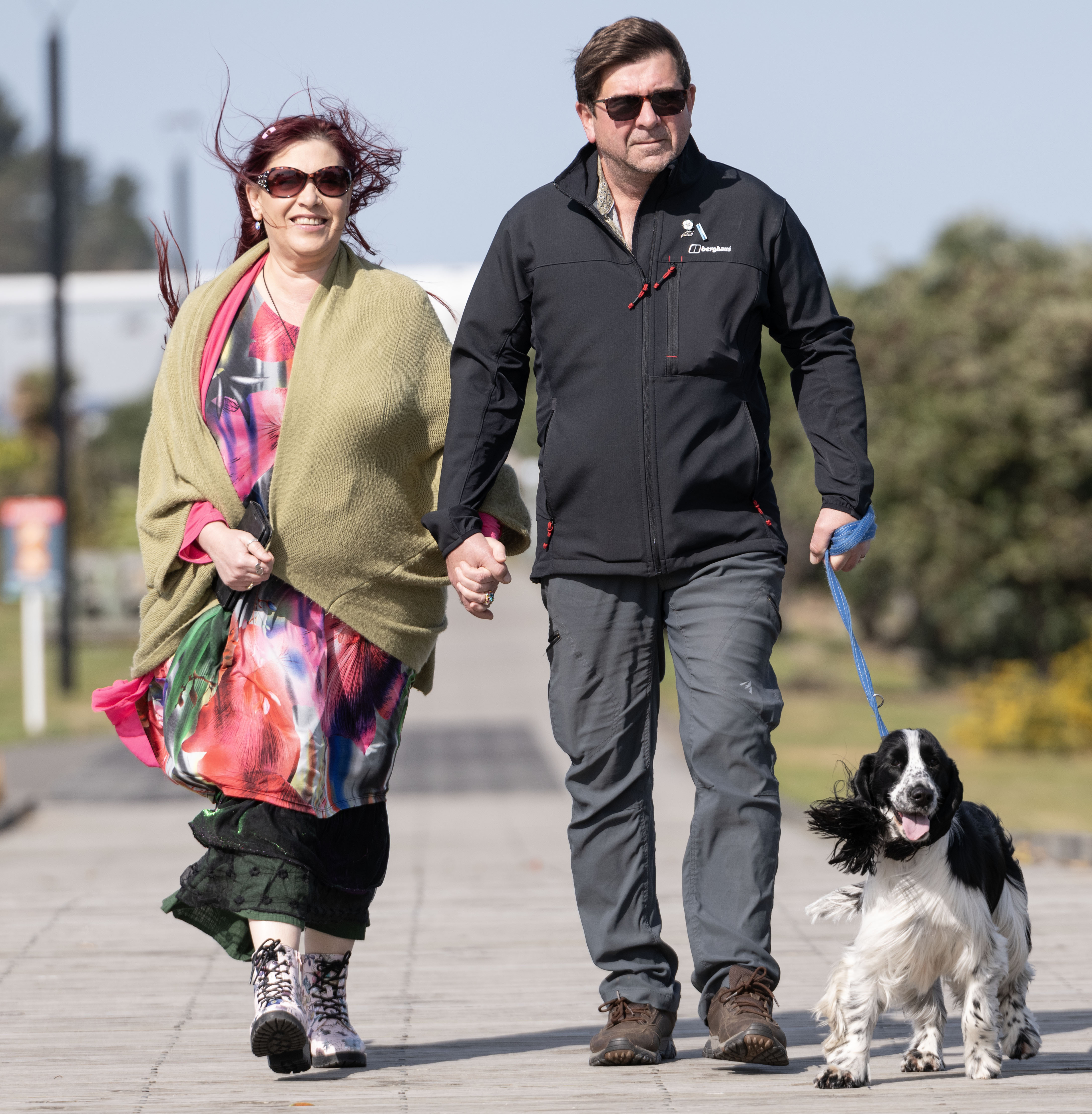 Lee Tempest and Brian Humphries, of Taradale, fighting the wind at Perfume Point on Sunday with dog Harley. Photo / Connull Lang