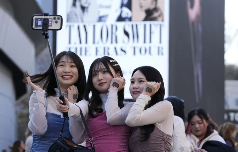 Women pose for a selfie before Taylor Swift's concert at Tokyo Dome in Tokyo. Photo / AP