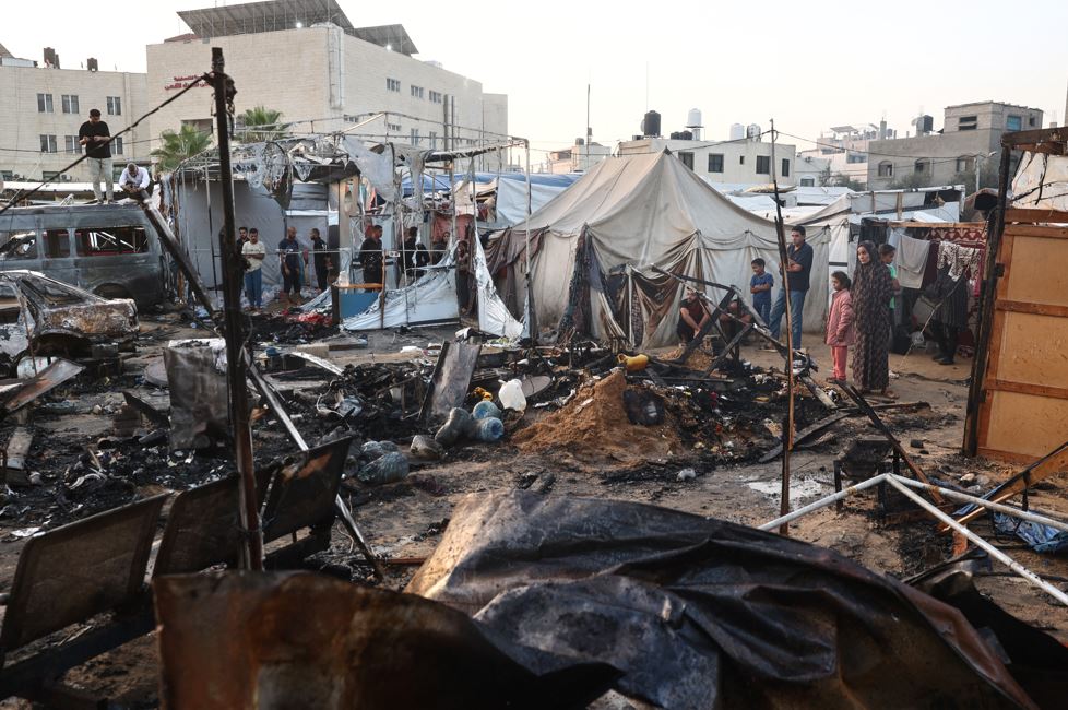 Palestinians check the destruction following an Israeli army strike around tents for displaced people inside the walls of Al-Aqsa Martyrs Hospital in Deir al-Balah, in the central Gaza Strip. Photo / AFP