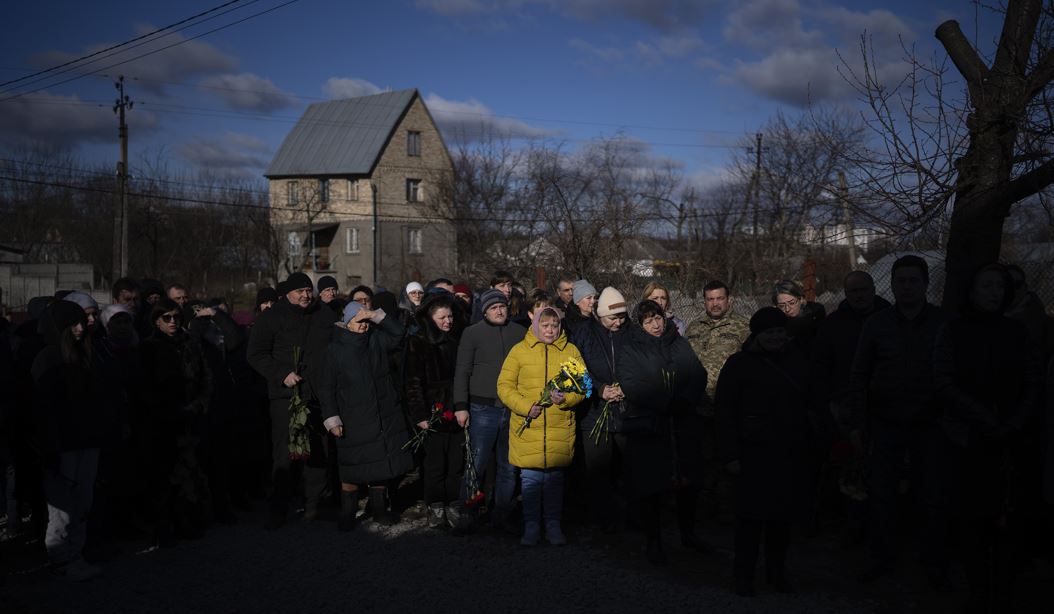 People pay respect as the coffin passes by during a funeral procession in Tarasivka village, near Kyiv, Ukraine, Photo / AP