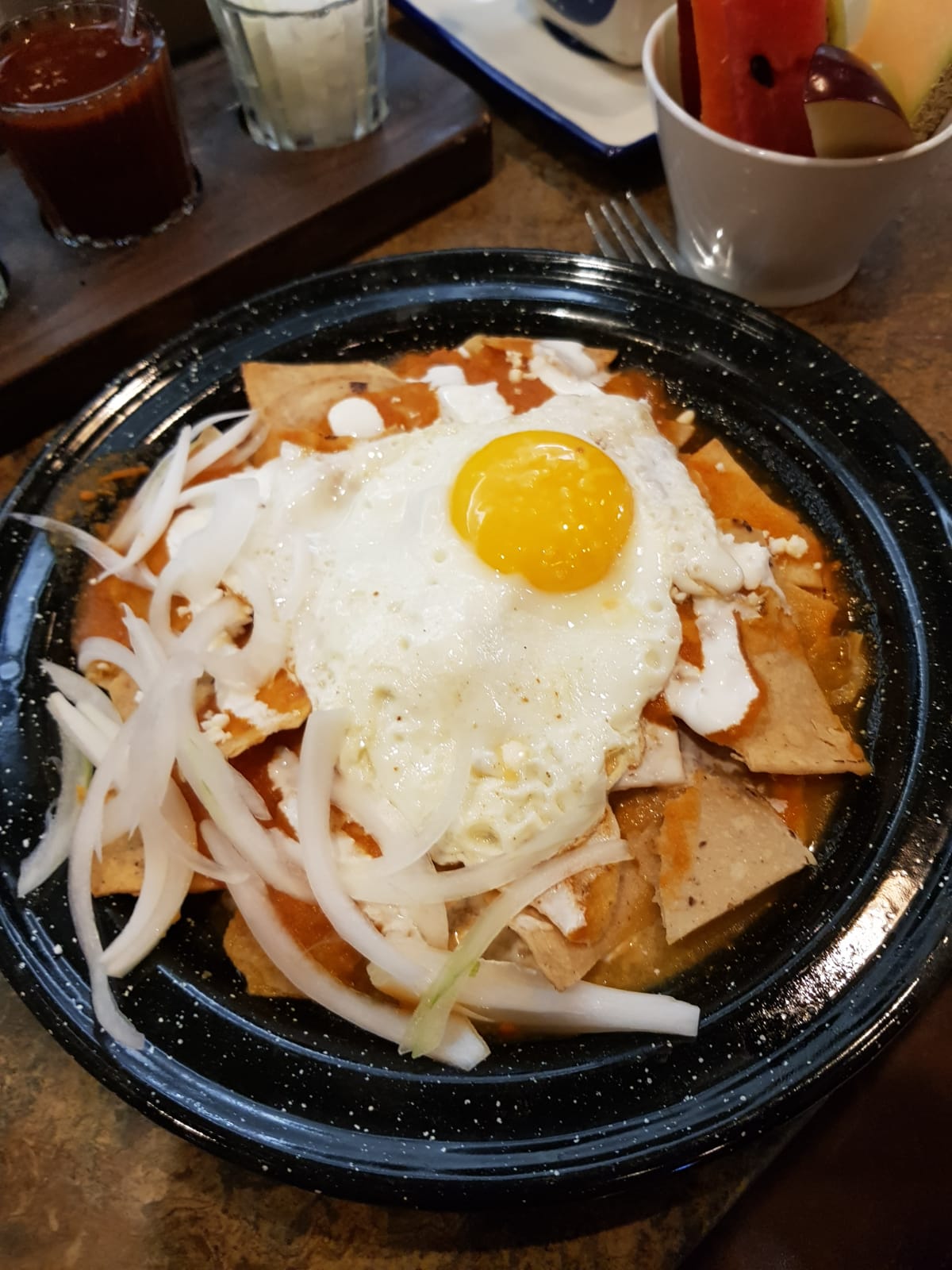 Chilaquiles, a Mexican dish, features crispy fried tortilla wedges smothered in red or green salsa, often served with eggs, beans, or chicken. Photo / Supplied