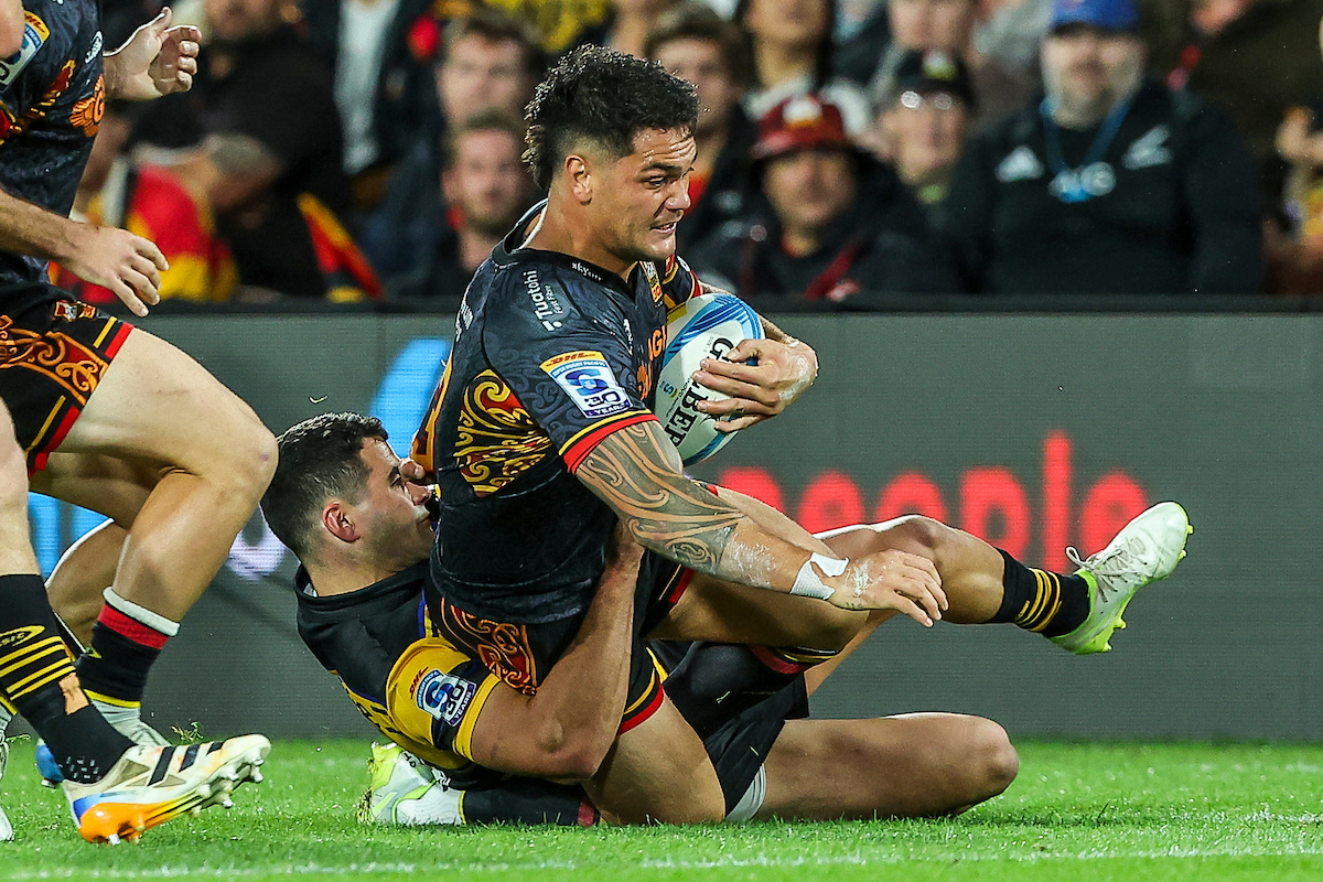 Chiefs midfielder Quinn Tupaea is brought down during the Chiefs clash against the Hurricanes. Photo / Photosport