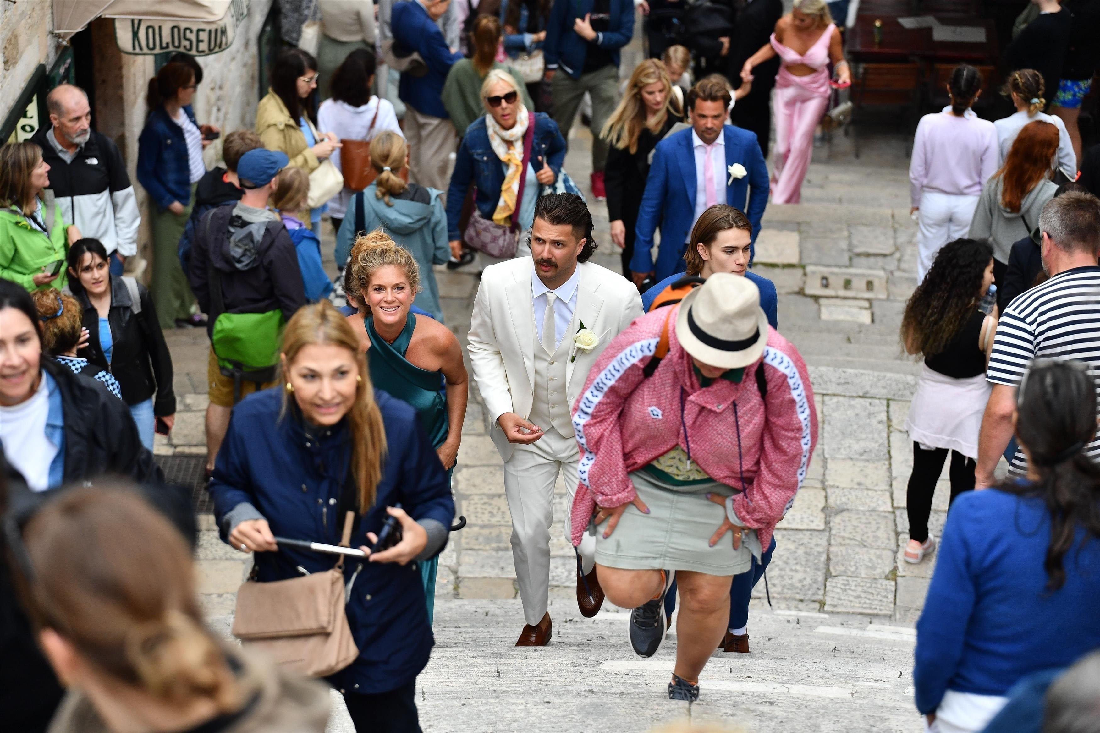 Rachel Hunter with her son Liam Stewart, walking into his wedding venue in Croatia. Photo / Backgrid Australia