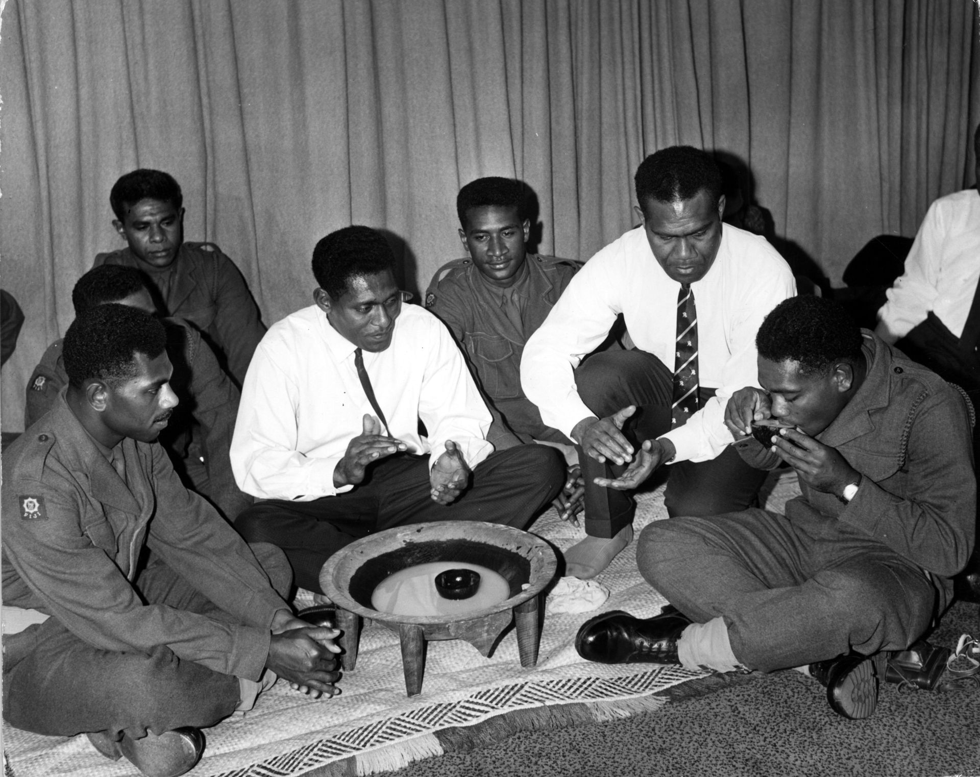 A detachment of soldiers from the Fiji army arrive at London Airport to take part in the Royal Tournament in 1965 and are greeted with a yaqona ceremony by local Fijians. Photo / Getty Images/File
