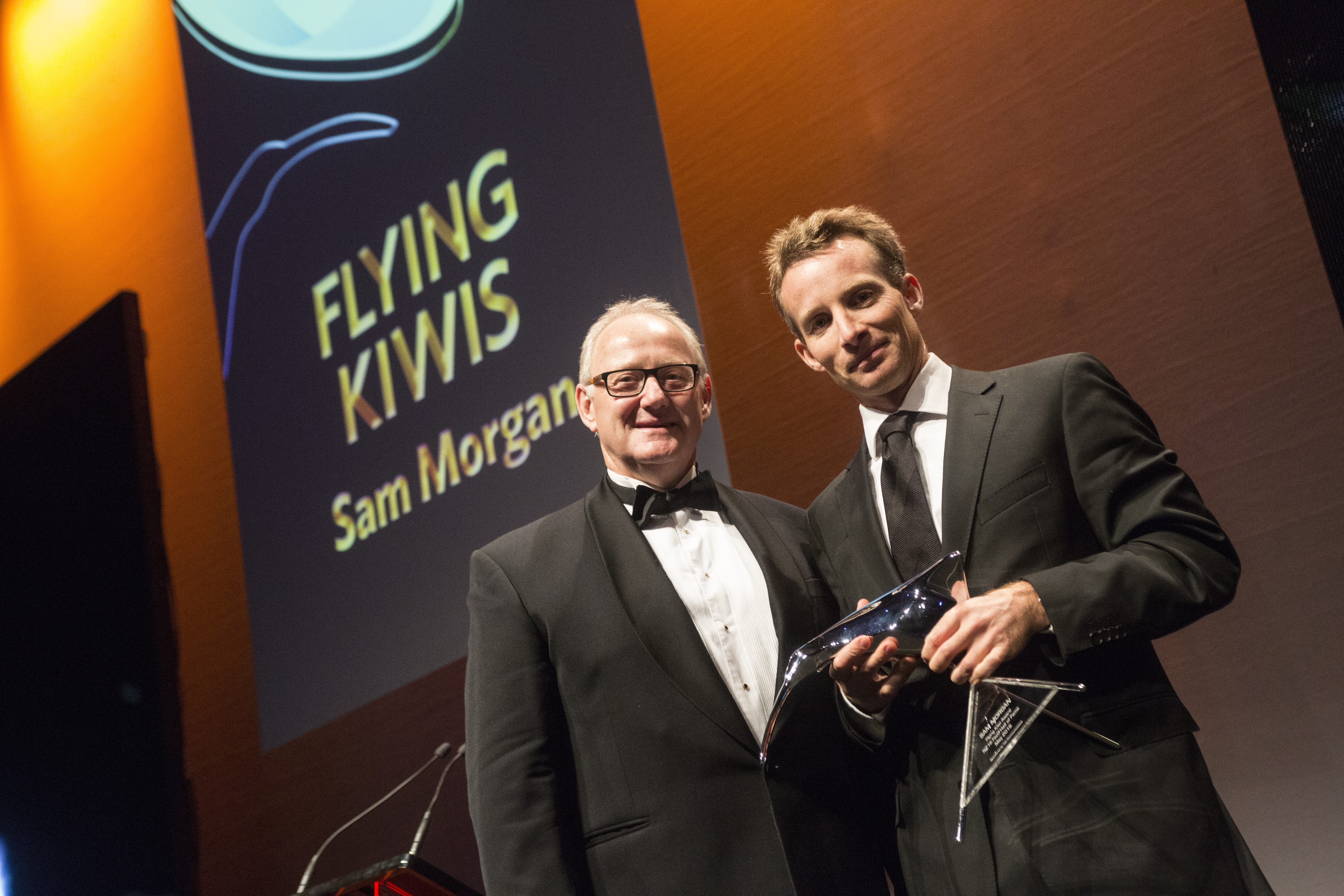 Sam Morgan (right) receives a Flying Kiwi Award from then Tait chief executive Garry Diack at the NZ High Tech Awards 2016.