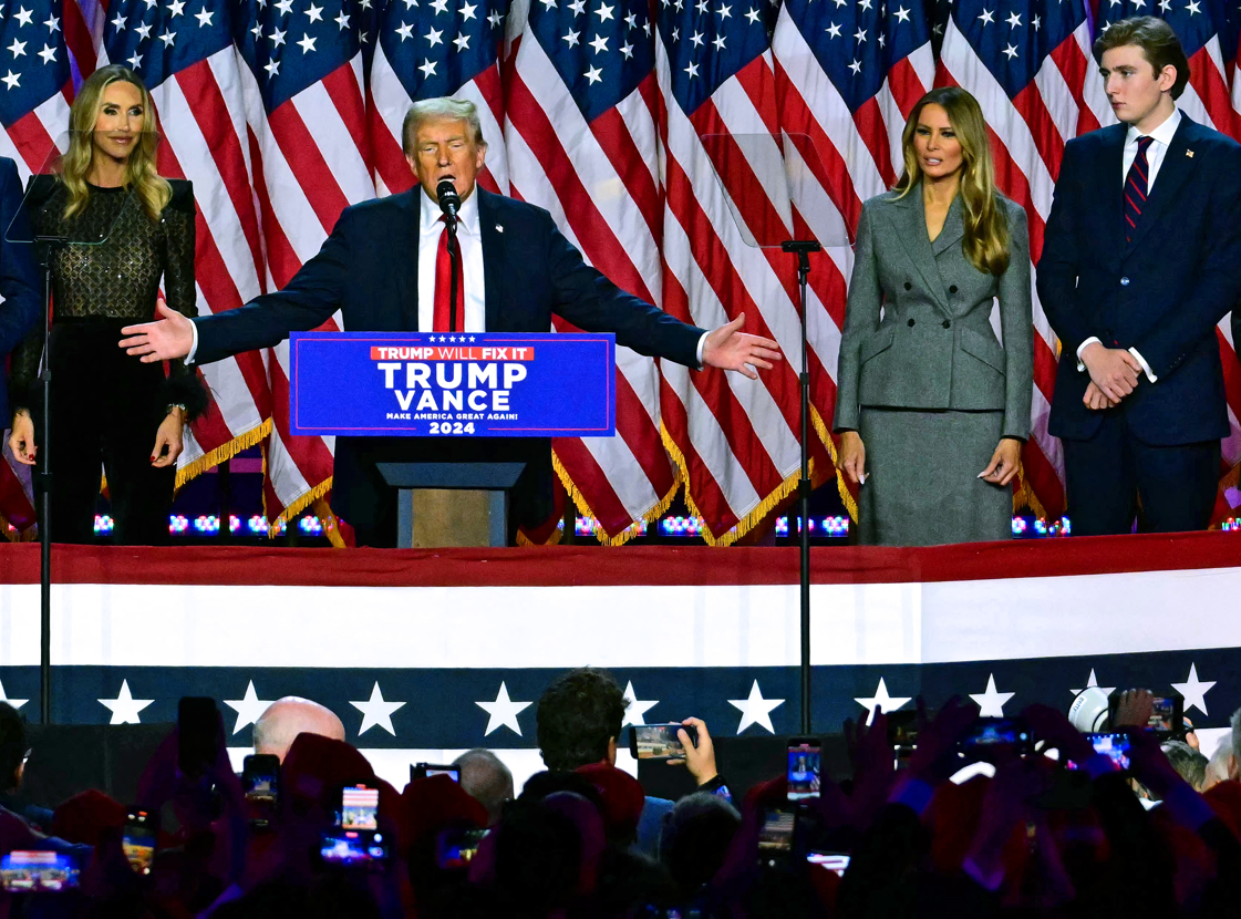 Donald Trump has claimed victory in the US election, flanked by wife Melania and son Barron. Photo / AFP
