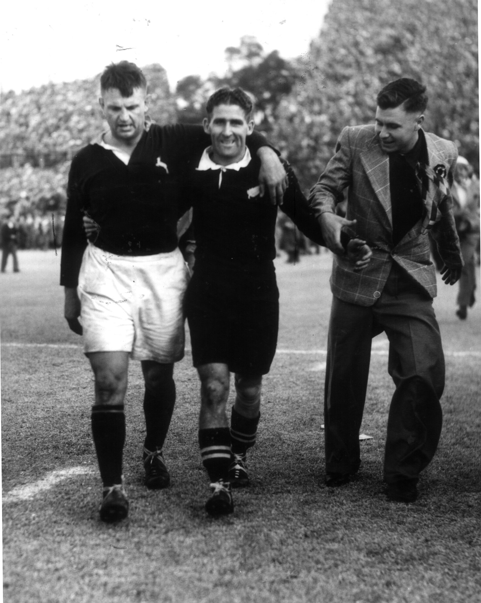 Sir Fred Allen (right) smiles for the camera as he walks off the field with Springbok F. Du Plessis after the Springboks won the second test in 1949. Photo / Rand Daily Mail