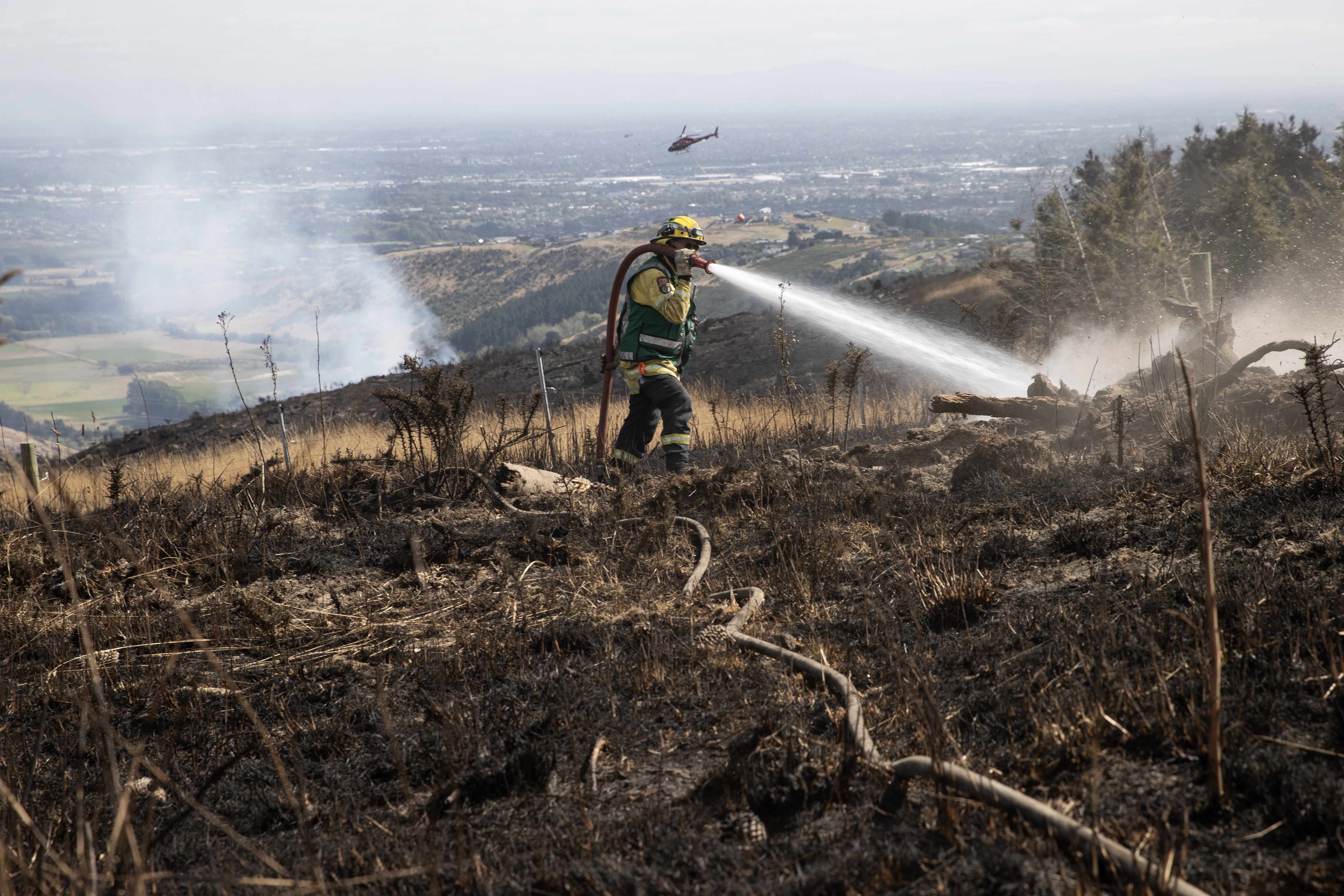 Dry, warm and windy conditions have posed a challenge for firefighters battling the latest big blaze at Christchurch's Port Hills. Photo / George Heard