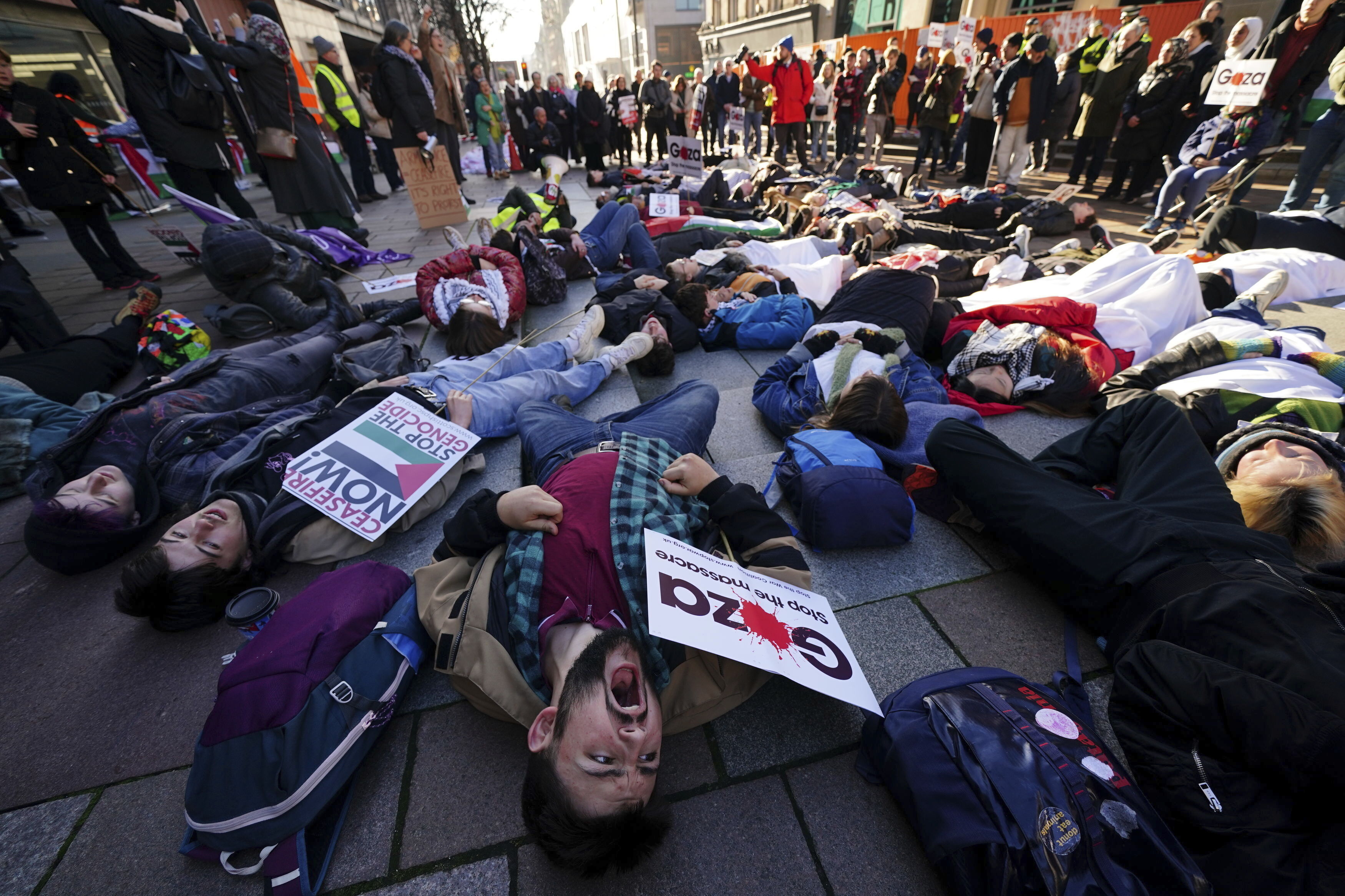 People take part in a die-in ahead of a Palestine Solidarity Campaign demonstration in Glasgow, Scotland. Photo / AP