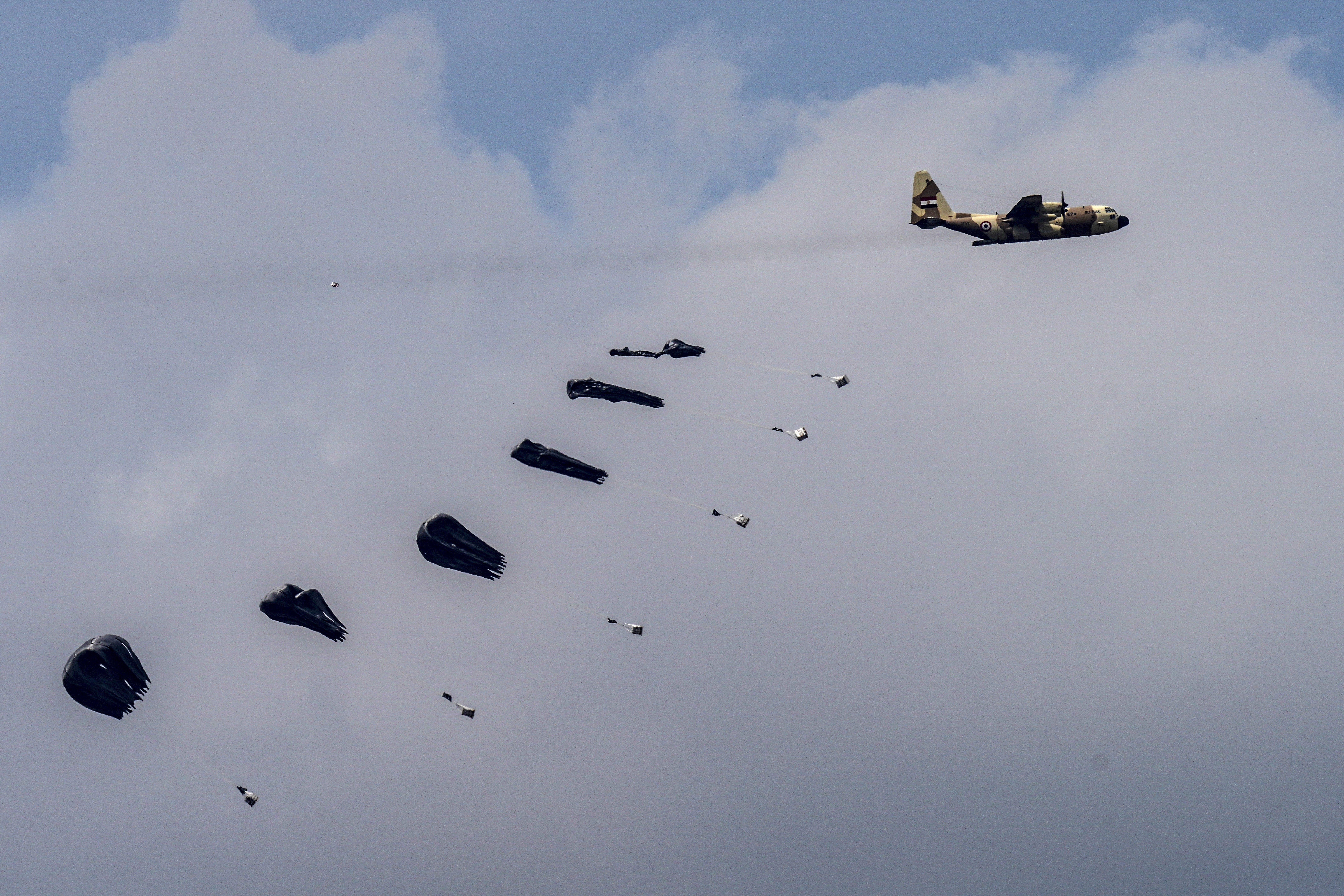 An aircraft airdrops humanitarian aid over the northern Gaza Strip, as seen from southern Israel. Photo / AP