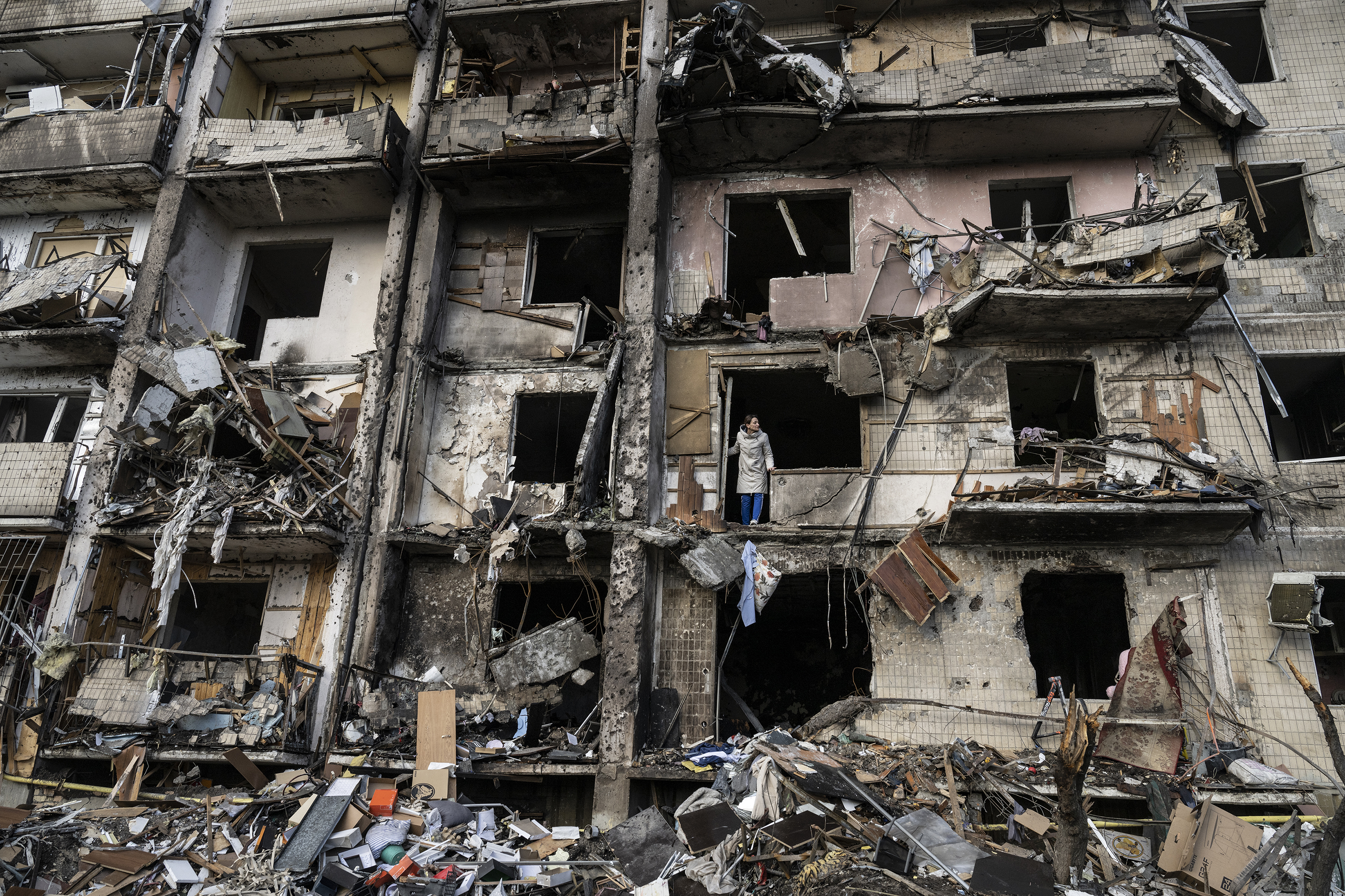 Ukrainians clean up debris after a residential building was hit by missiles in south Kyiv, Ukraine, February 25, 2022. Photo / Lynsey Addario, The New York Times
