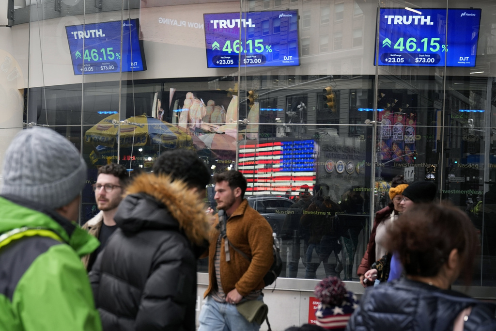 Pedestrians walk past the Nasdaq building as the stock price of Trump Media & Technology Group Corp is displayed earlier this year. Photo /Frank Franklin II, AP, File