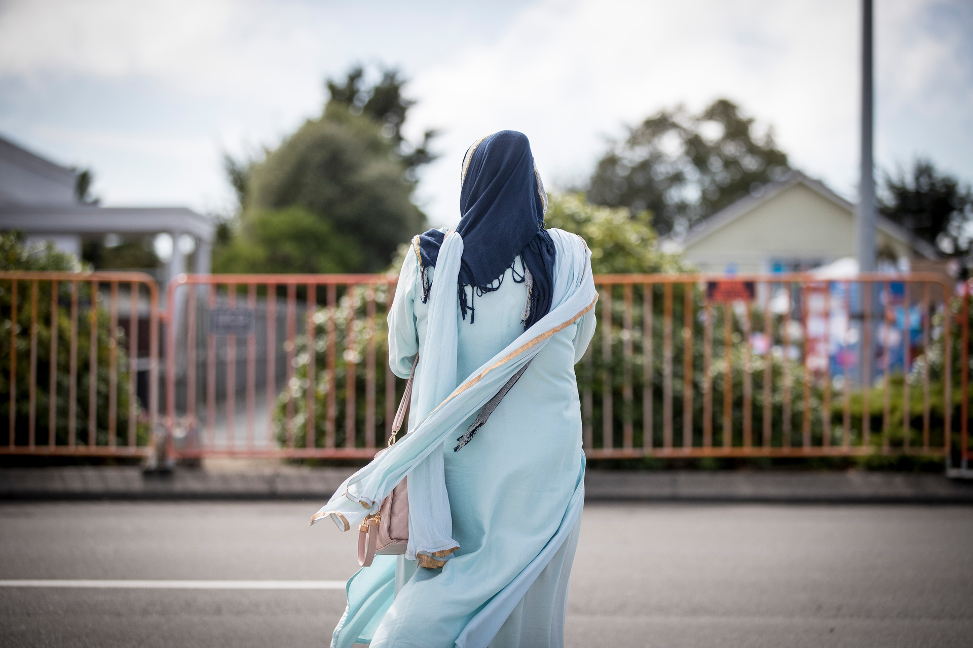 A mourner outside the Linwood Islamic Centre a week after the Christchurch terror attacks. Photo / Michael Craig