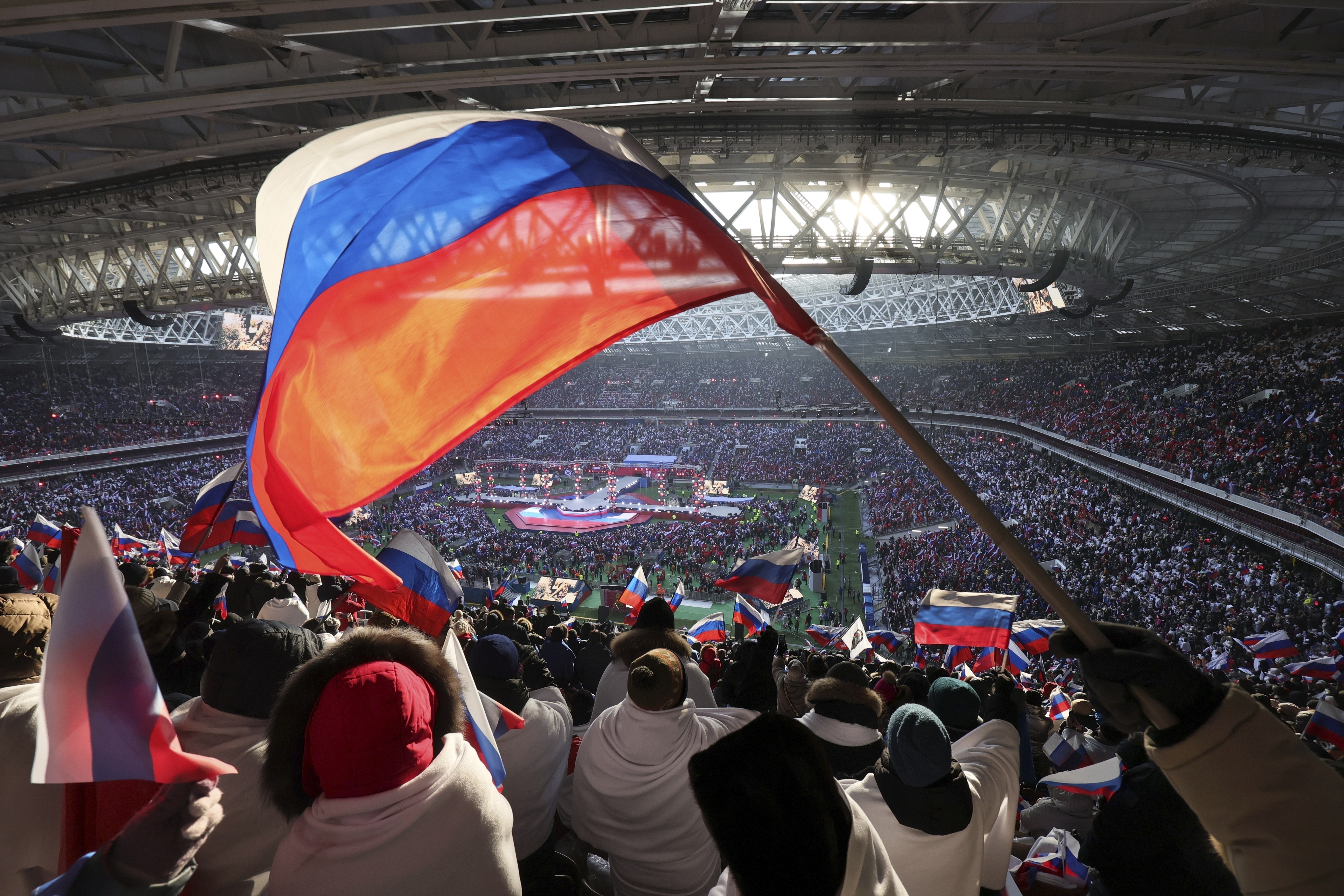 Participants wave Russian flags during the 